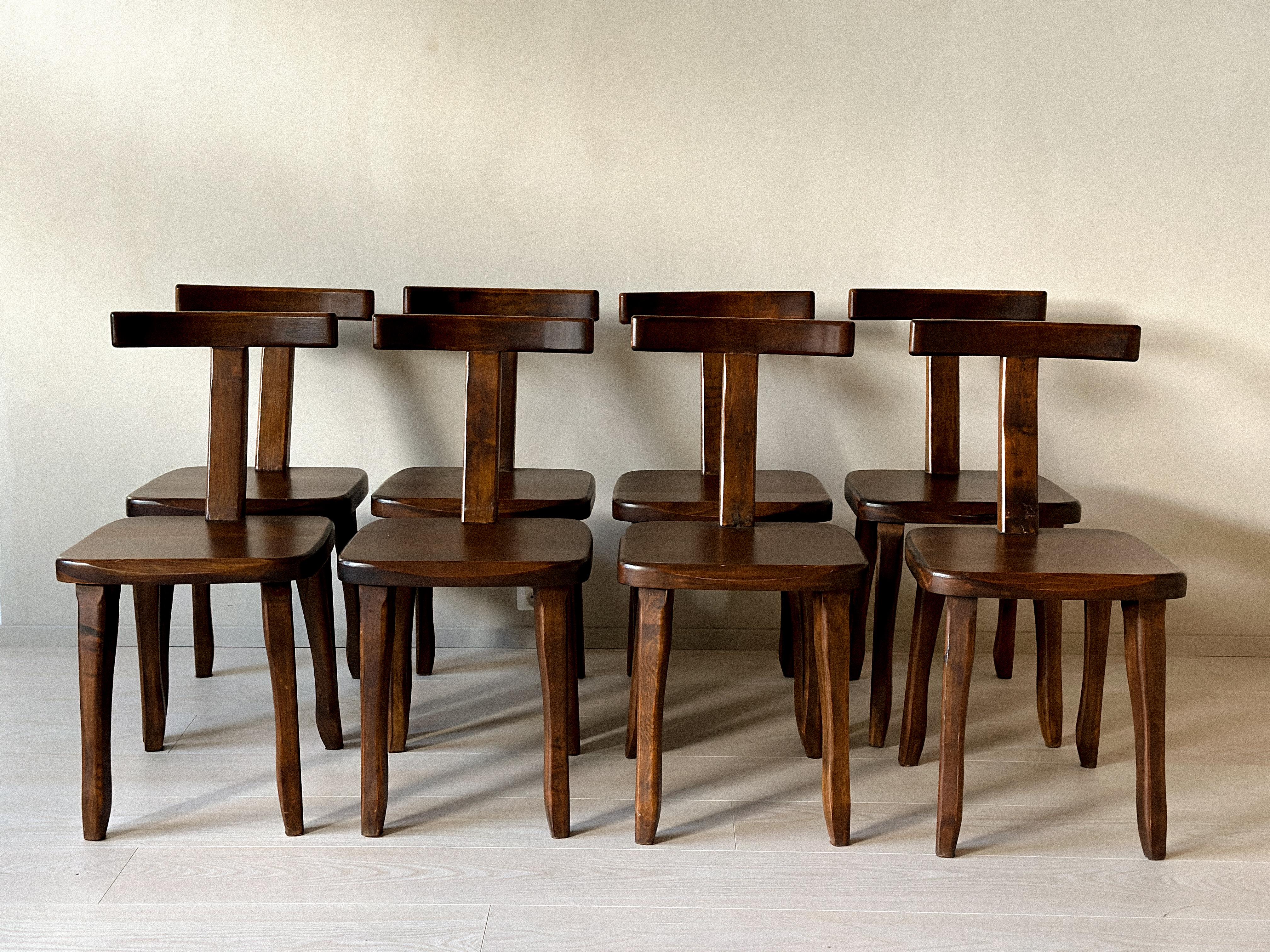 A wonderful set of 8 brutalist dining chairs manufactured by Aranjou, France c. 1960s. Massive dark stained oak and organic shape. 

Wear consistent of age and use. Marks, scratches. 

