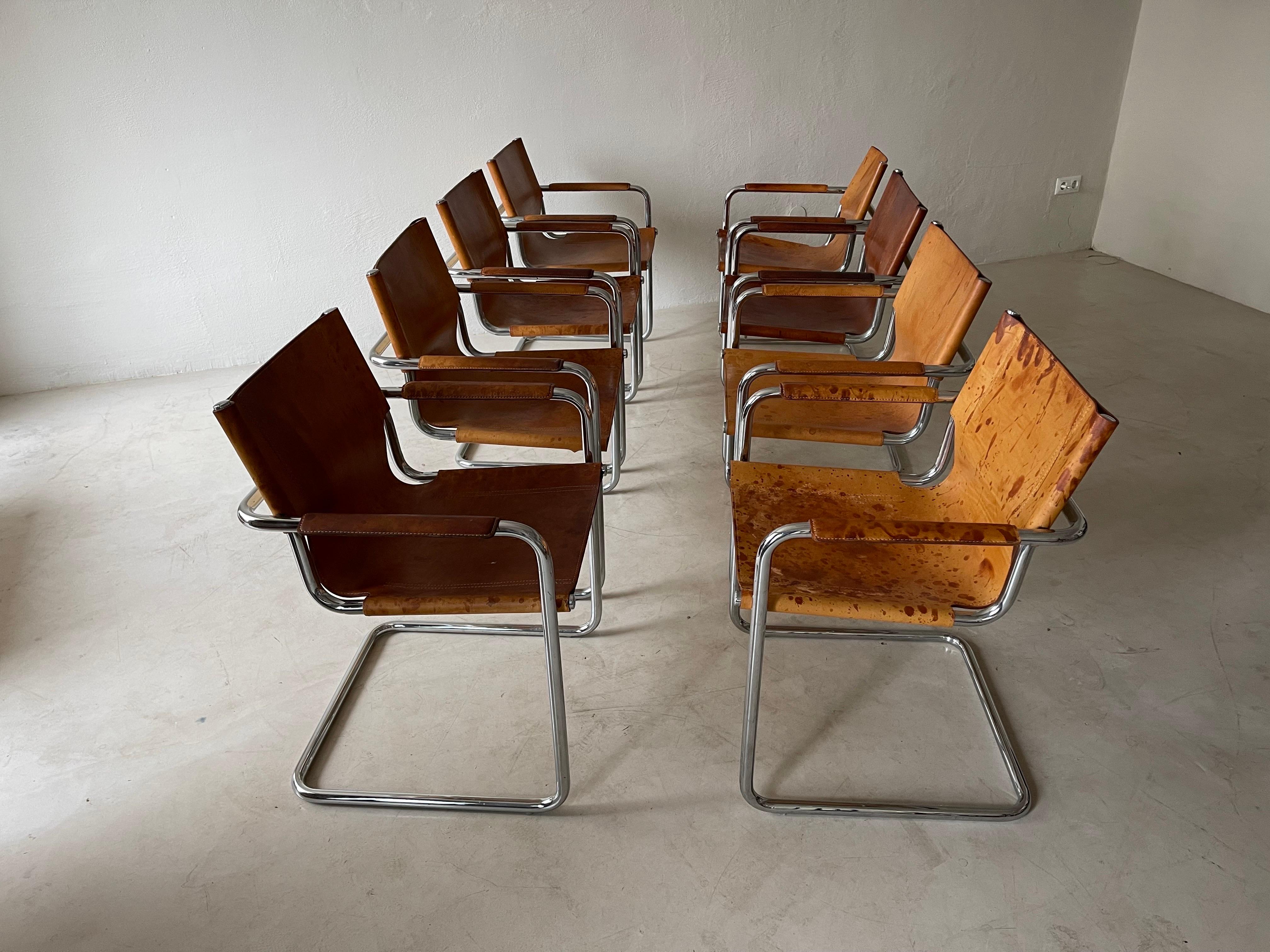 Rare set of 8 cantilever armchairs in very patinated cognac leather by Matteo Grassi. Amazing patina that is so sought after and impossible to re-create. Made in Italy in the 1970s. 