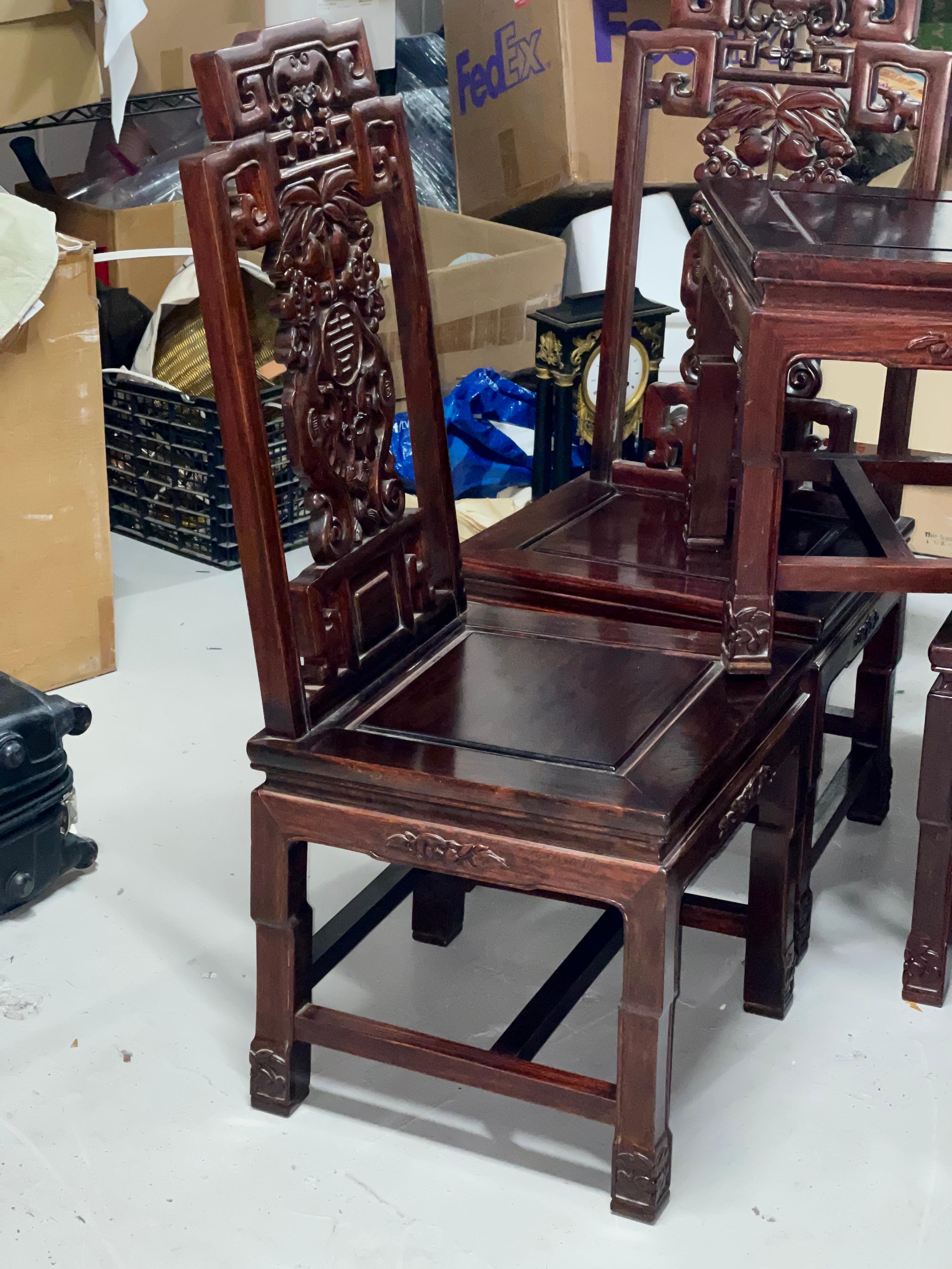 An elegant set of 8 Chinese carved hardwood chairs. 2 arms and 6 side chairs in the set. There are some form of Chinese rosewood like Huang Huali. Likely first half of the 20th century. They are in good condition with some minor signs of wear and