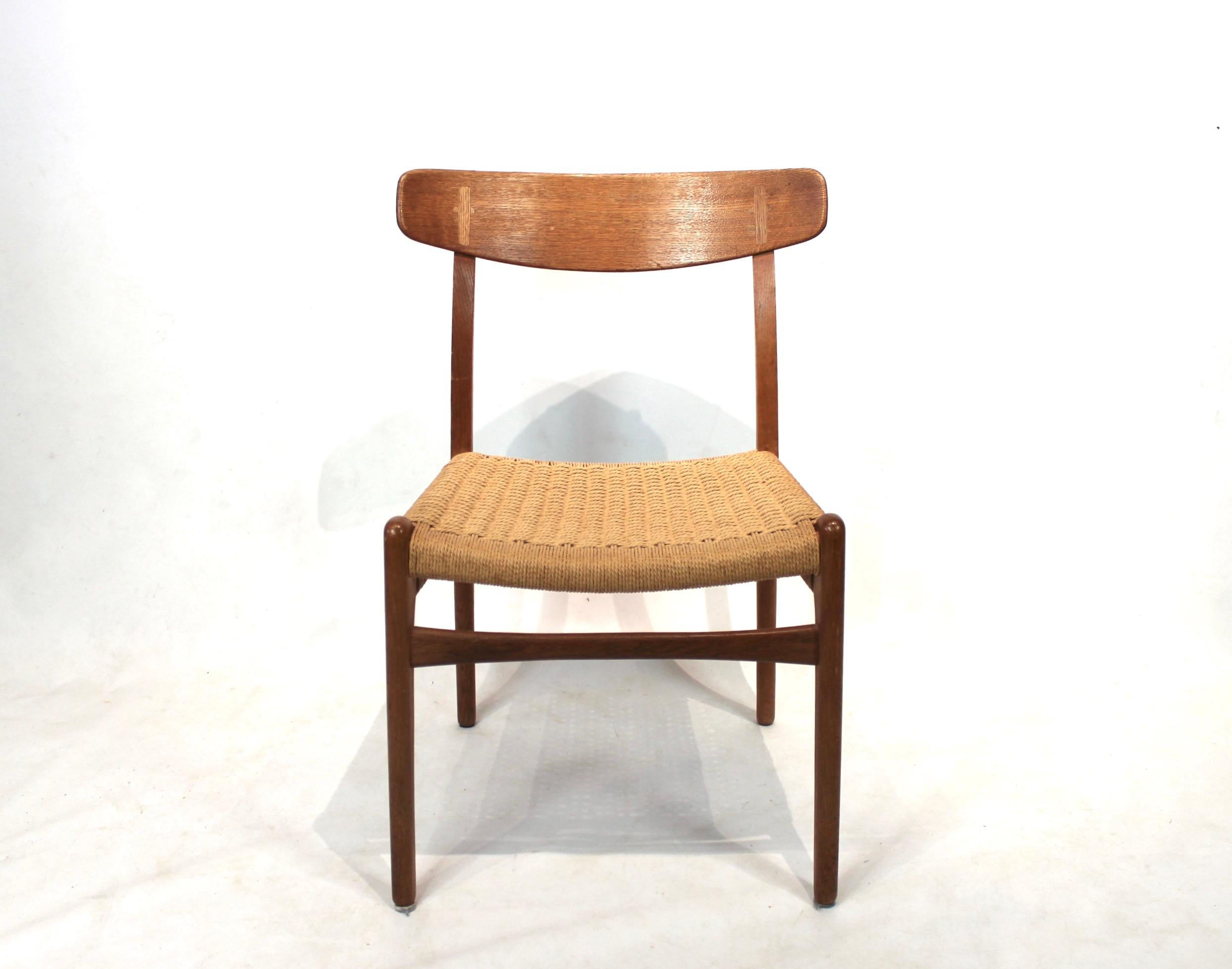 Set of 8 dining chairs, model CH23, designed by Hans Wegner in 1950 and manufactured by Carl Hansen & Son in the 1950s. The chairs are of oak, with seats of paper cord and are all in great vintage condition.
 