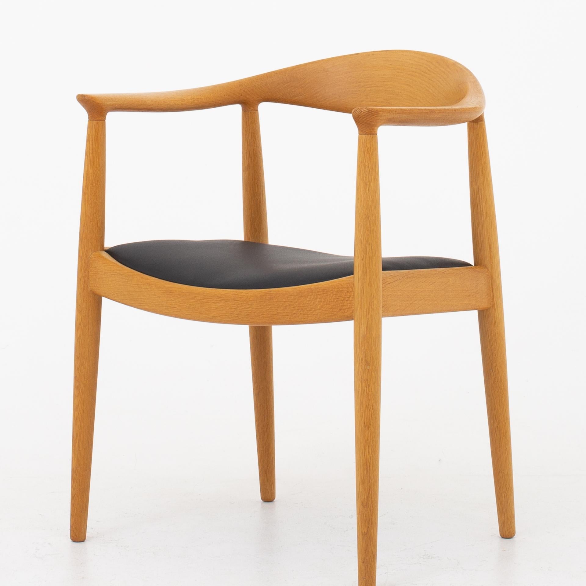 Set of 8 JH 503, the chair in lacquered oak with seat in black leather. Maker Johannes Hansen.