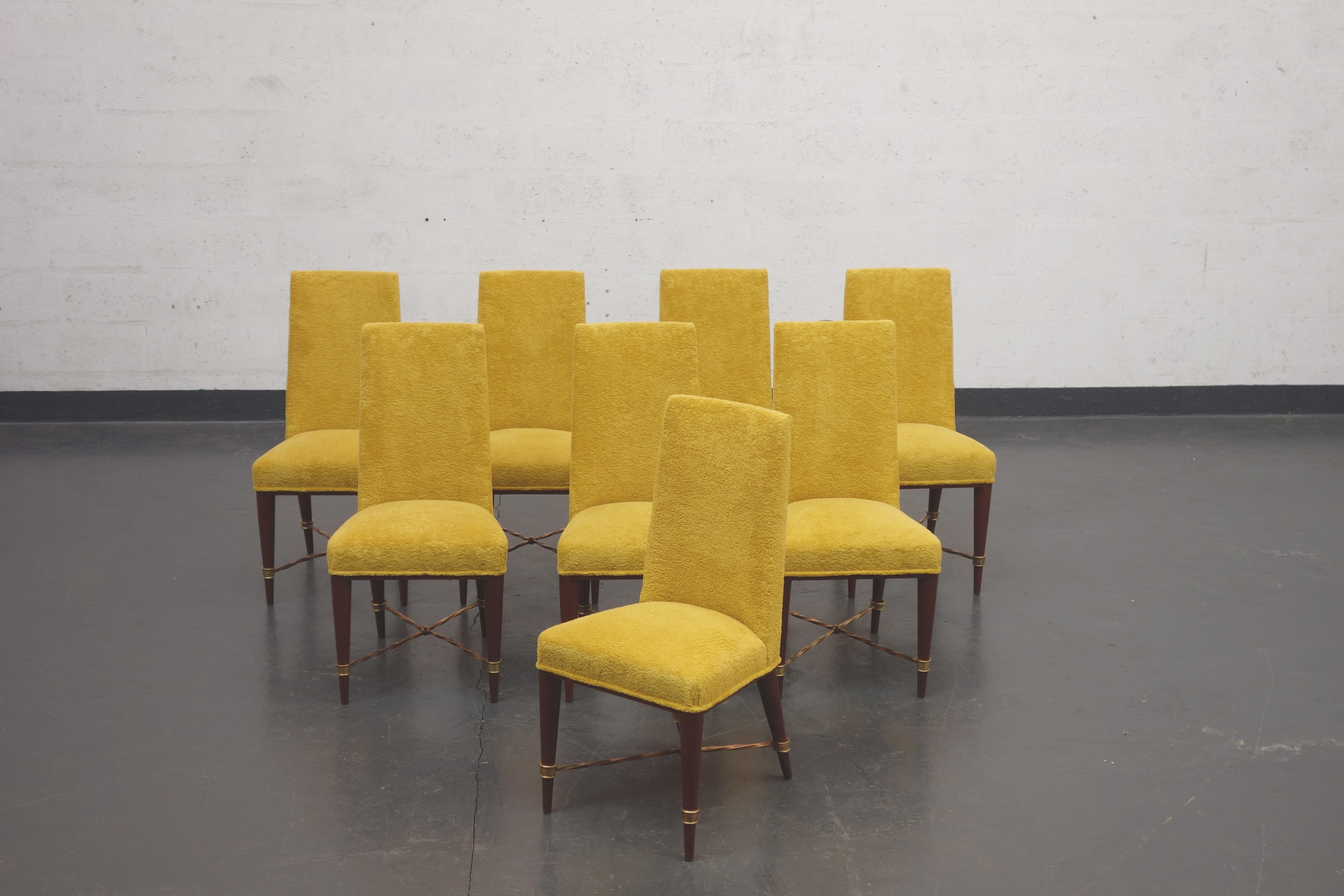 Set of 8 chairs by Jean Royère, 1957 
Wood structure. On each leg, a gilded bronze ring with twisted W-shaped rods. 
The back is flat, lightly curved. These chairs have been upholstered with a yellow terry towel fabric. 

Provenance: Special