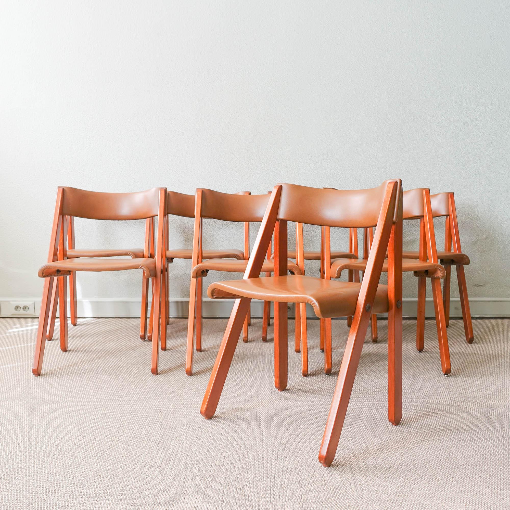This set of eight chairs was designed by Gastão Machado for Móveis Olaio, Portugal, in 1978. Gastão Machado designed this model for young people's room, however its detachable molded plywood structure also allowed it to be used quite successfully in