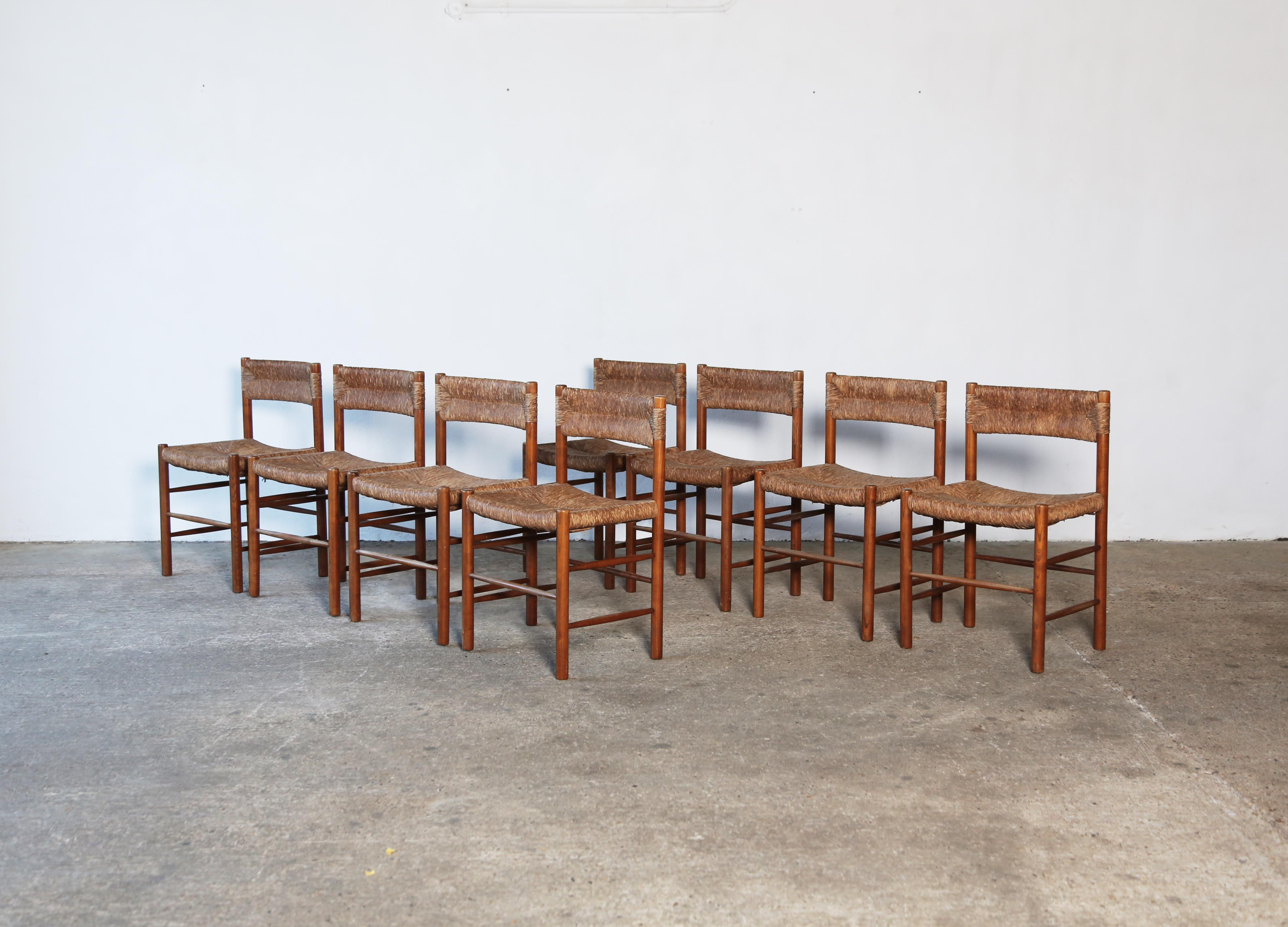 A rare set of eight original Charlotte Perriand / Robert Sentou Dordogne chairs, France, 1960s. Original rush seats and backs in good condition with superb patina.  Fast shipping worldwide.
