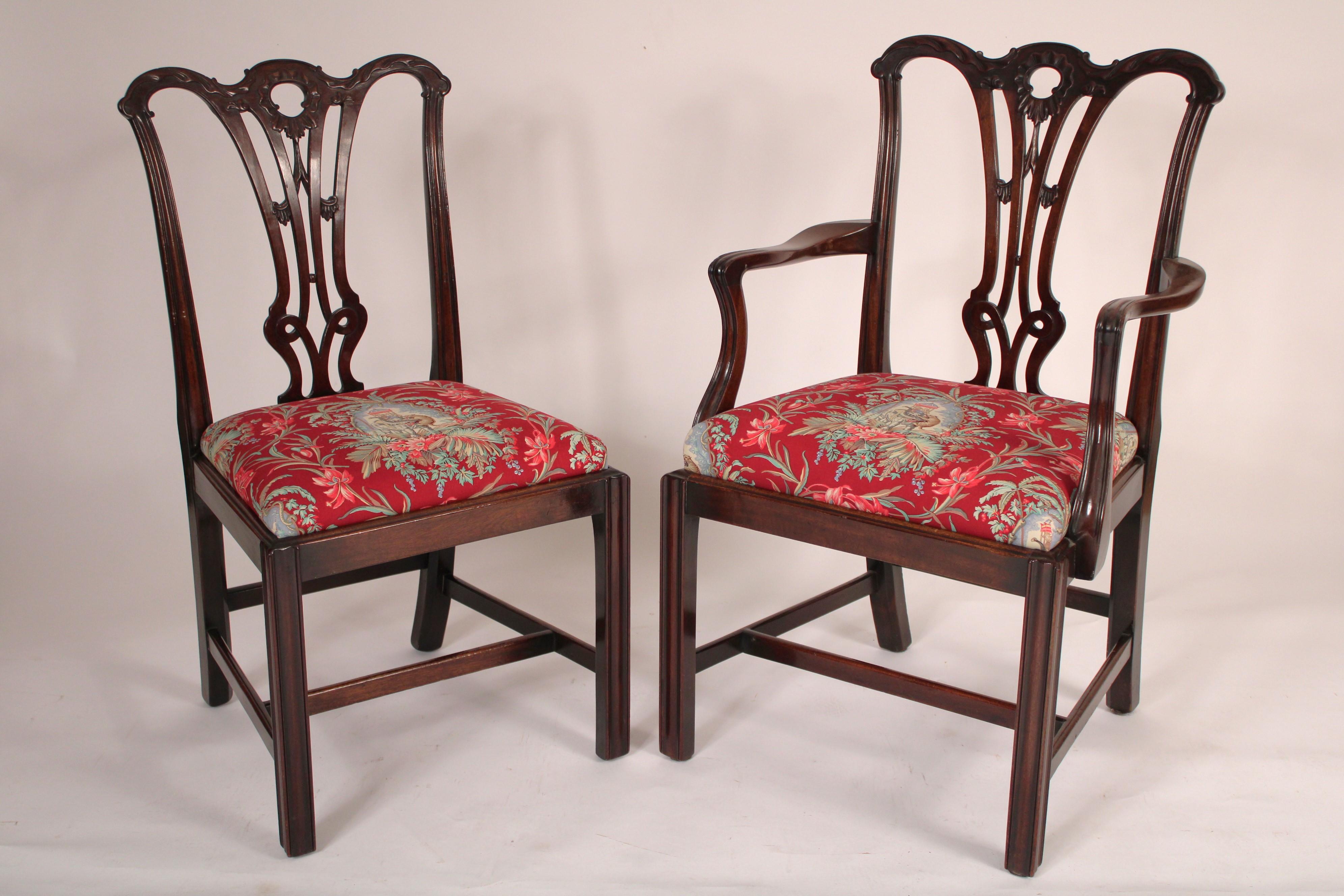 Set of 8 Chippendale style mahogany dining room chairs, circa 1920's. With a carved cupids bow crest rail, a pierced back splat with swag carving, molded stiles, resting on Chippendale style 5 sided legs, joined by H shaped stretcher bars. With