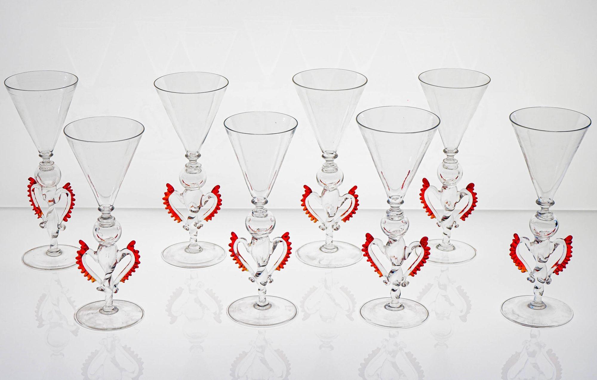 Great Signed Cenedese set of 8 historical goblets, highly detailed.

The stem is made by a twisted solid glass surmounted by a small blown sphere and a typical Cenedese neck. On the side high elaborated wings 