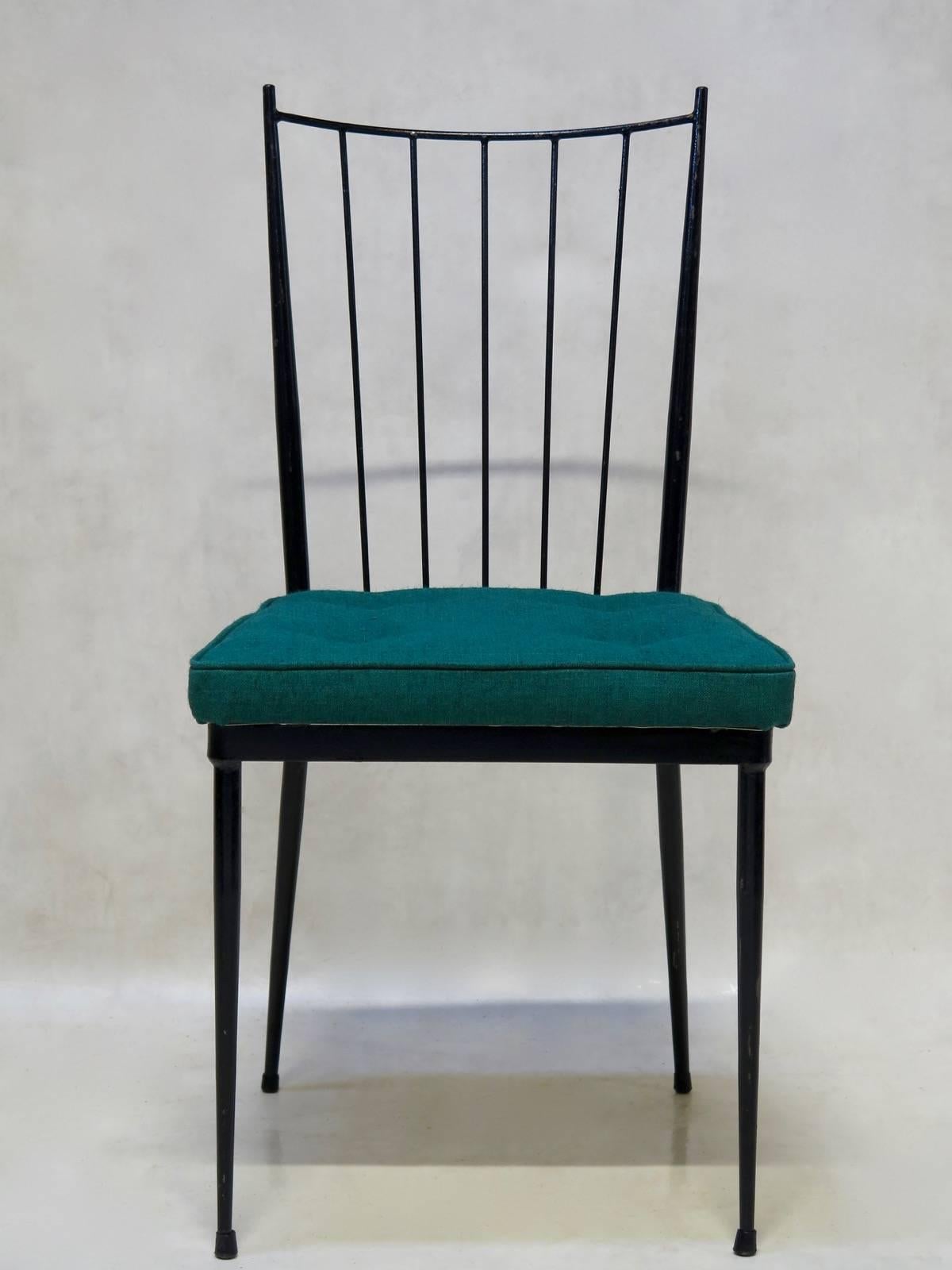 Chic and sturdy yet lightweight set of eight black-painted metal chairs attributed to French designer Colette Gueden. The backs are curved, the seats wide and generous, upholstered in teal-colored fabric. True to the values of the era, they combine