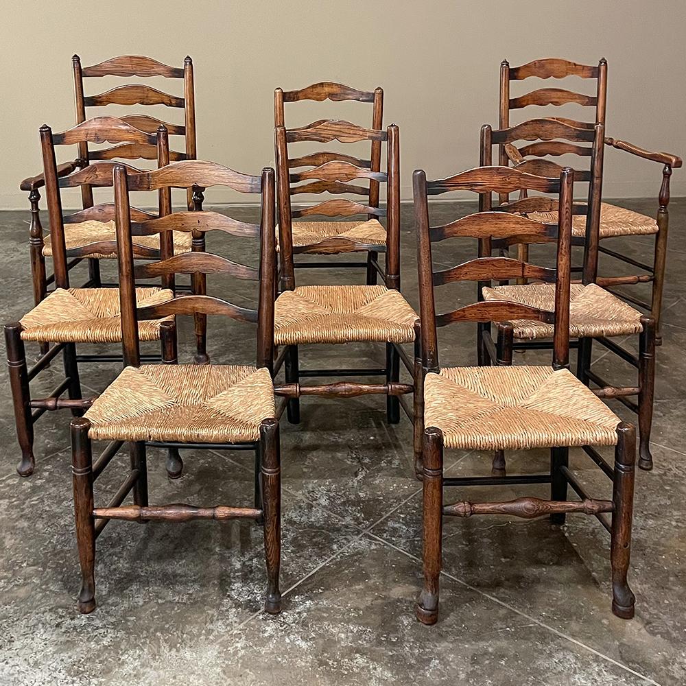 Set of 8 Country French Dining Chairs with Rush Seats includes 2 Armchairs are of a classic ladderback design, and feature turned upright posts connected with turned stretchers with wraparound rush seats in the traditional French rural design. This