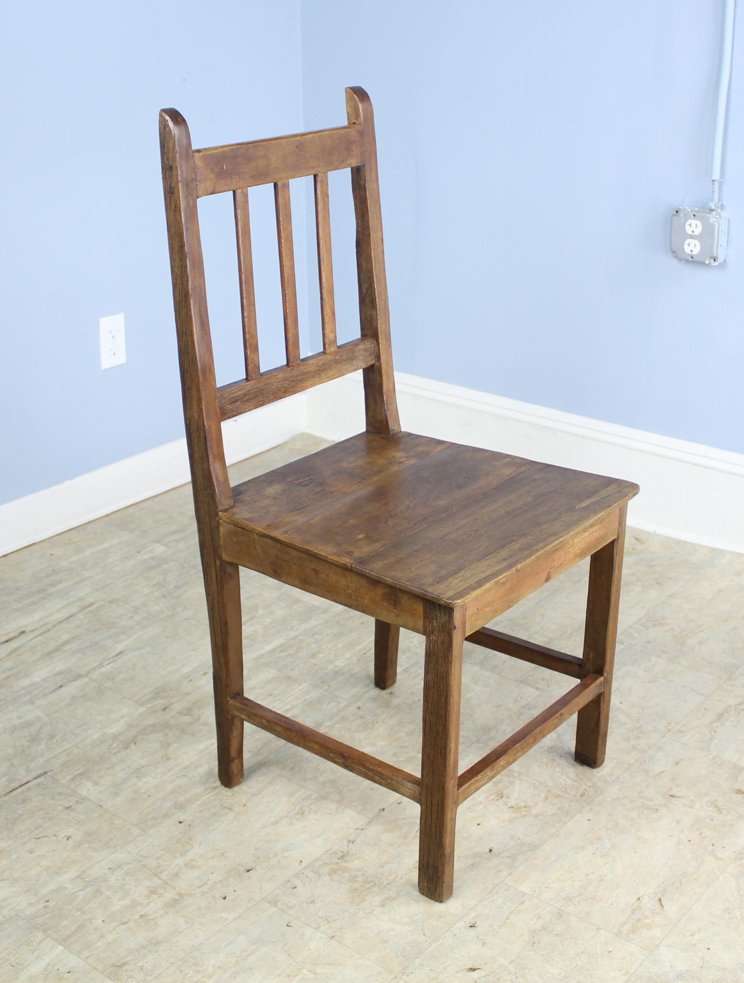 A charming set of English oak side chairs. A simple silhouette with lovely color and patina. The seats, pictured in images #6 and 7, have various degrees of wear, but all chairs are in sturdy good condition. Would look smart around a country farm