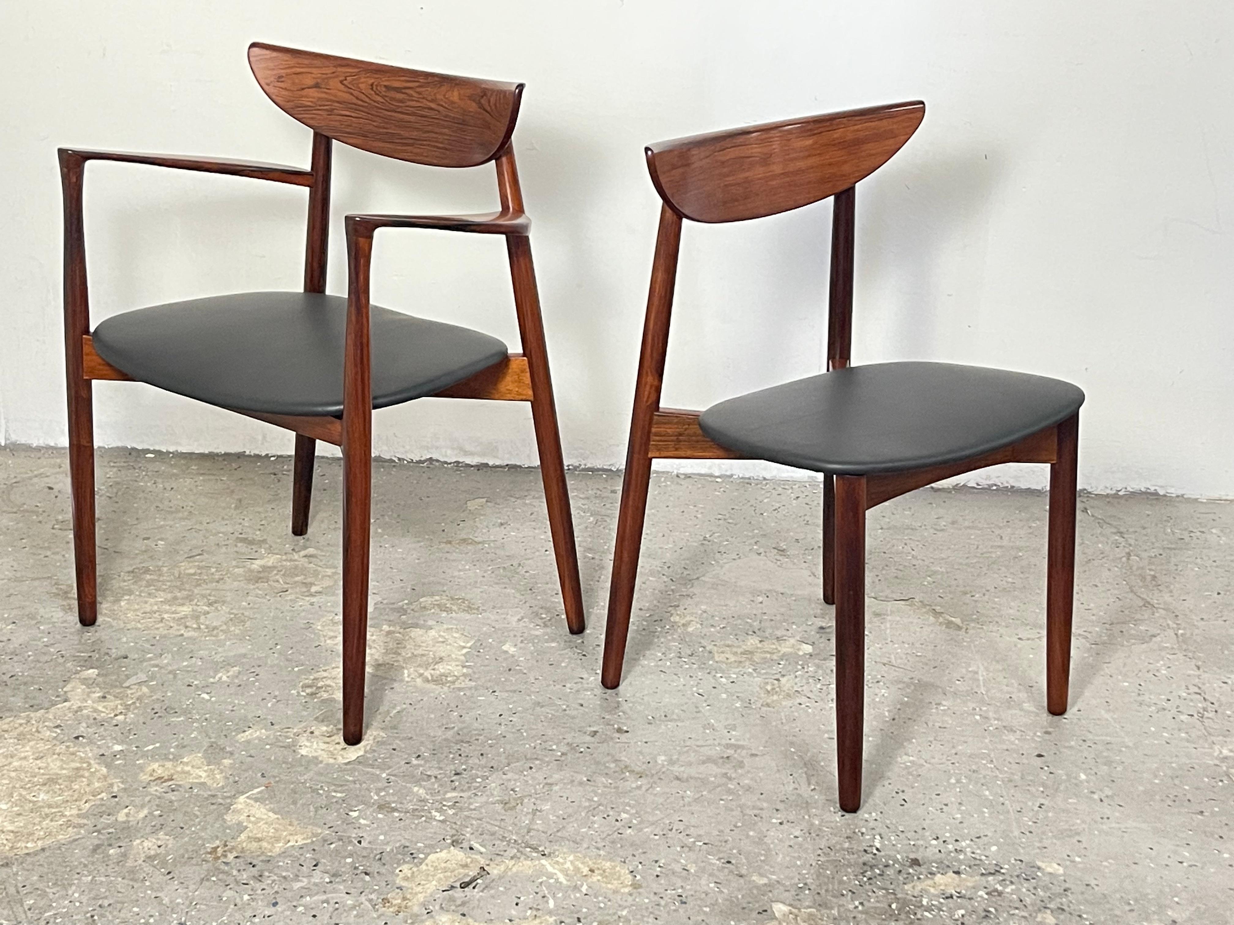 Set of 8 beautiful and sleek Solid Rosewood dining chairs by one of the Danish great designers Harry Ostergaard Manufactured by Moreddi of Denmark. Featuring graceful lines with a rounded curved back and tapered legs. Similar to Hans Wegner and Finn