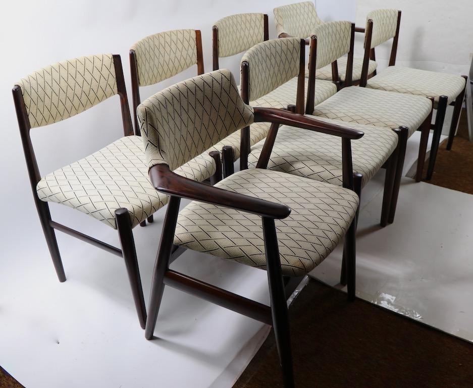 Very rare set of 8 rosewood dining chairs by Grete Jalk to include 2 armchairs and 6 side chairs. All chairs are in very good original condition, fabric shows some cosmetic wear, stains etc. Stunning rosewood frames, great architectural design,
