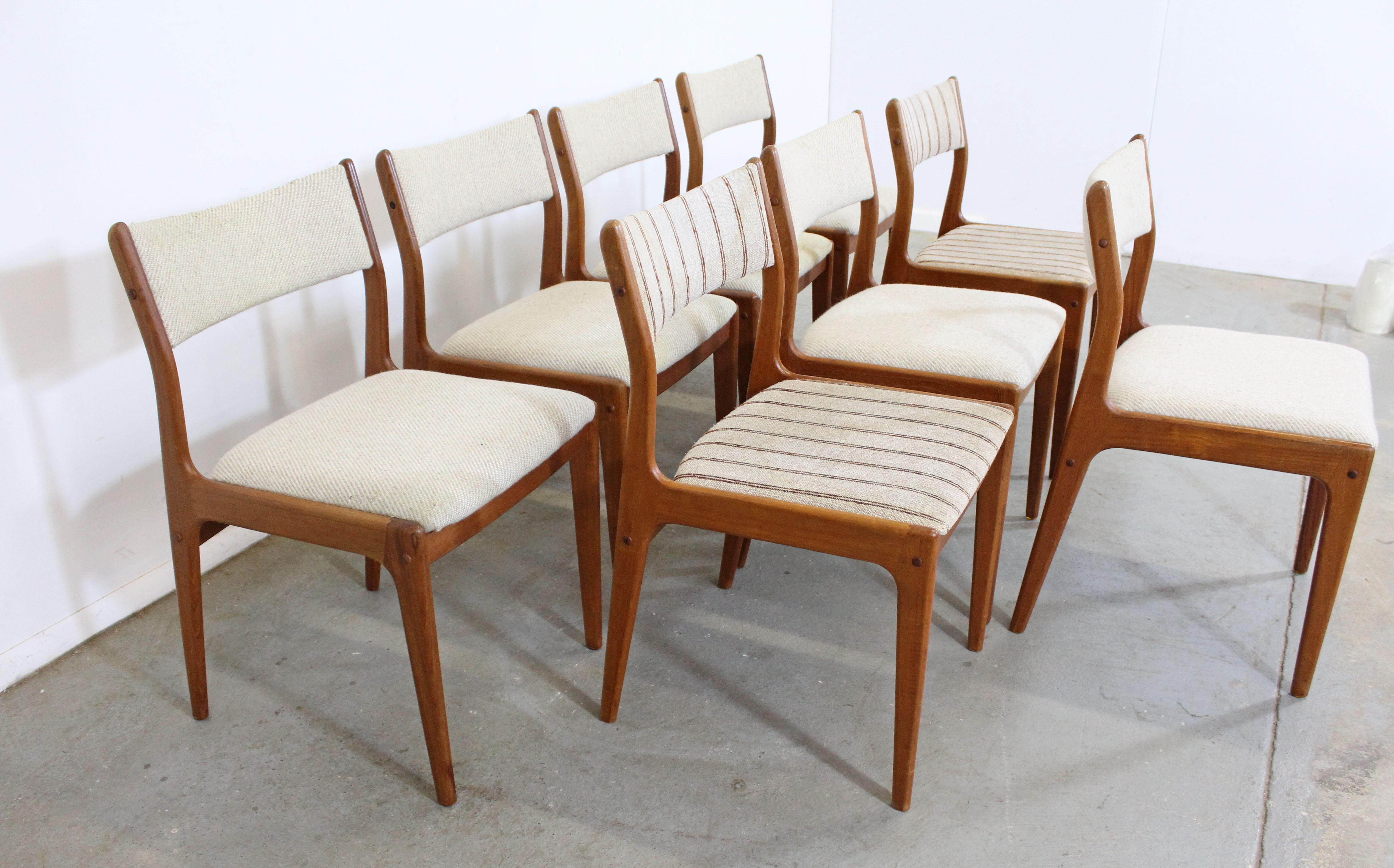 Offered is a set of 8 Danish Modern teak dining chairs designed by Johannes Andersen for Uldum Mobelfabrik. Includes 8 teak side chairs. The set is in vintage condition, need to be reupholstered, showing stains and tears on the fabric, a previous