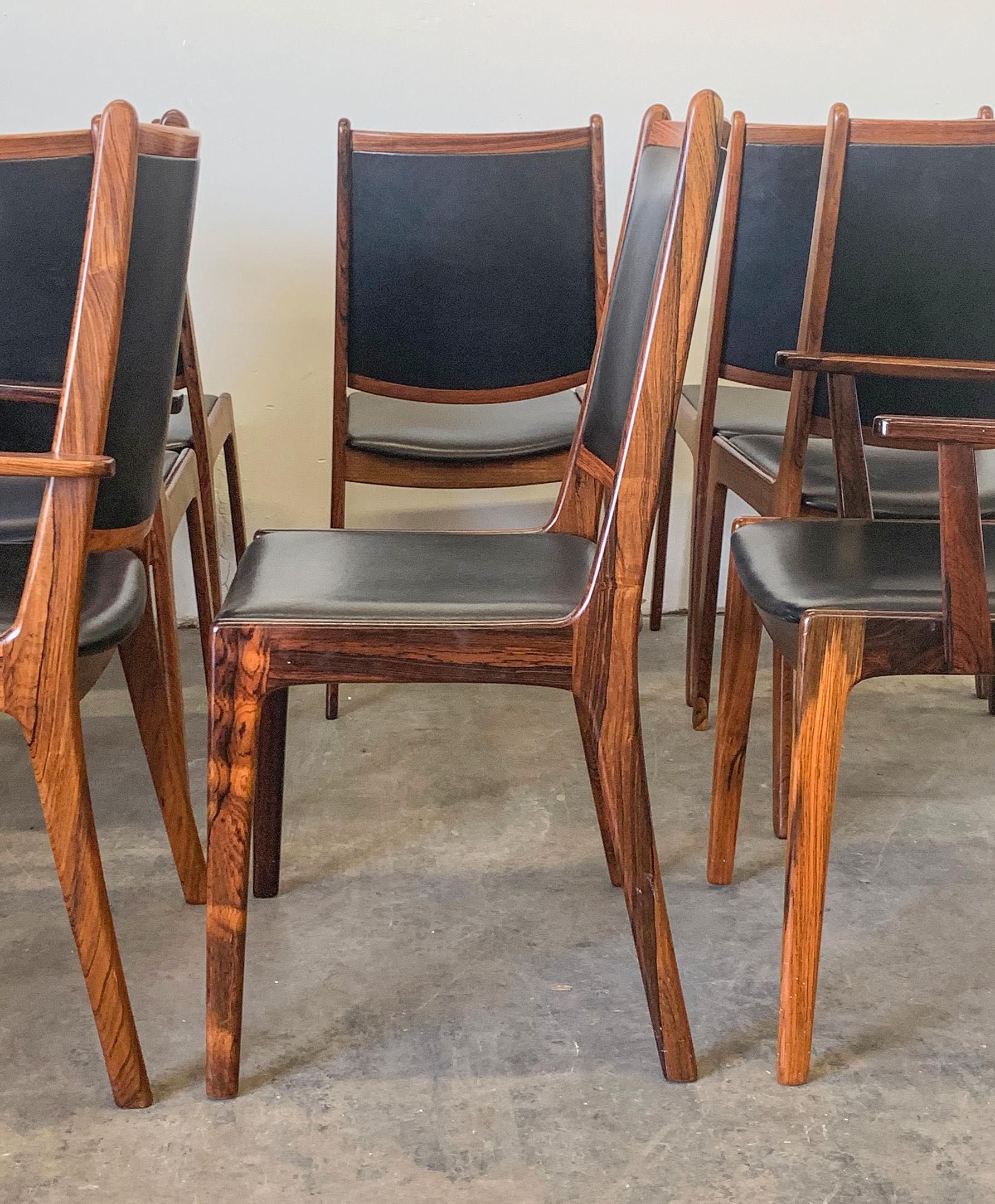 Available right now we have this stunning set of 8 Danish modern rosewood dining chairs. The rosewood grain on these chairs is absolutely stunning! Striking grain, and luxurious black leather make these chairs such sumptuous statement pieces.