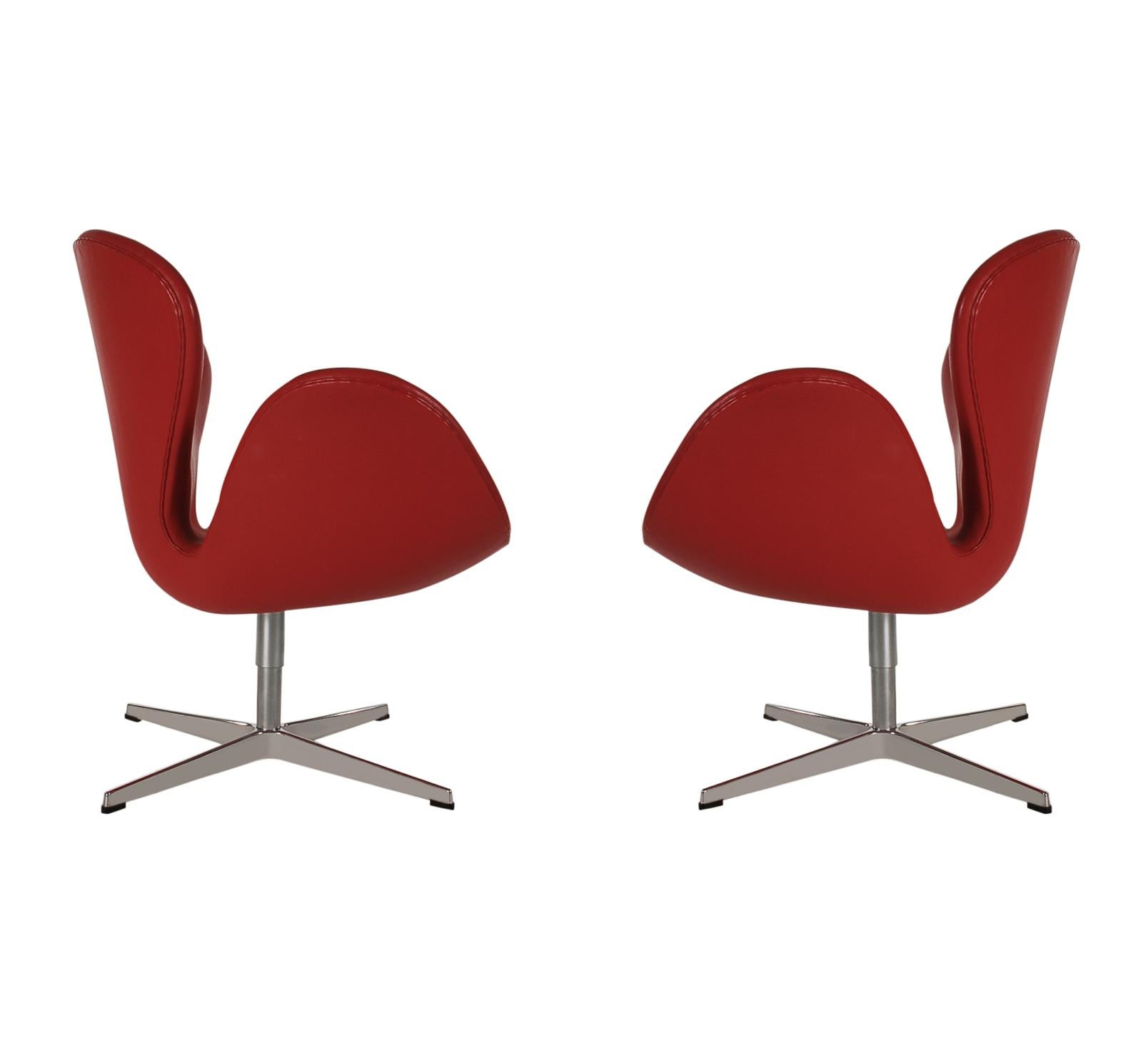An incredible opportunity to purchase a set of eight matching swan chairs designed by Arne Jacobsen and produced by Fritz Hansen in 2012. These are covered in supple red leather. They all swivel and return to their original position automatically.