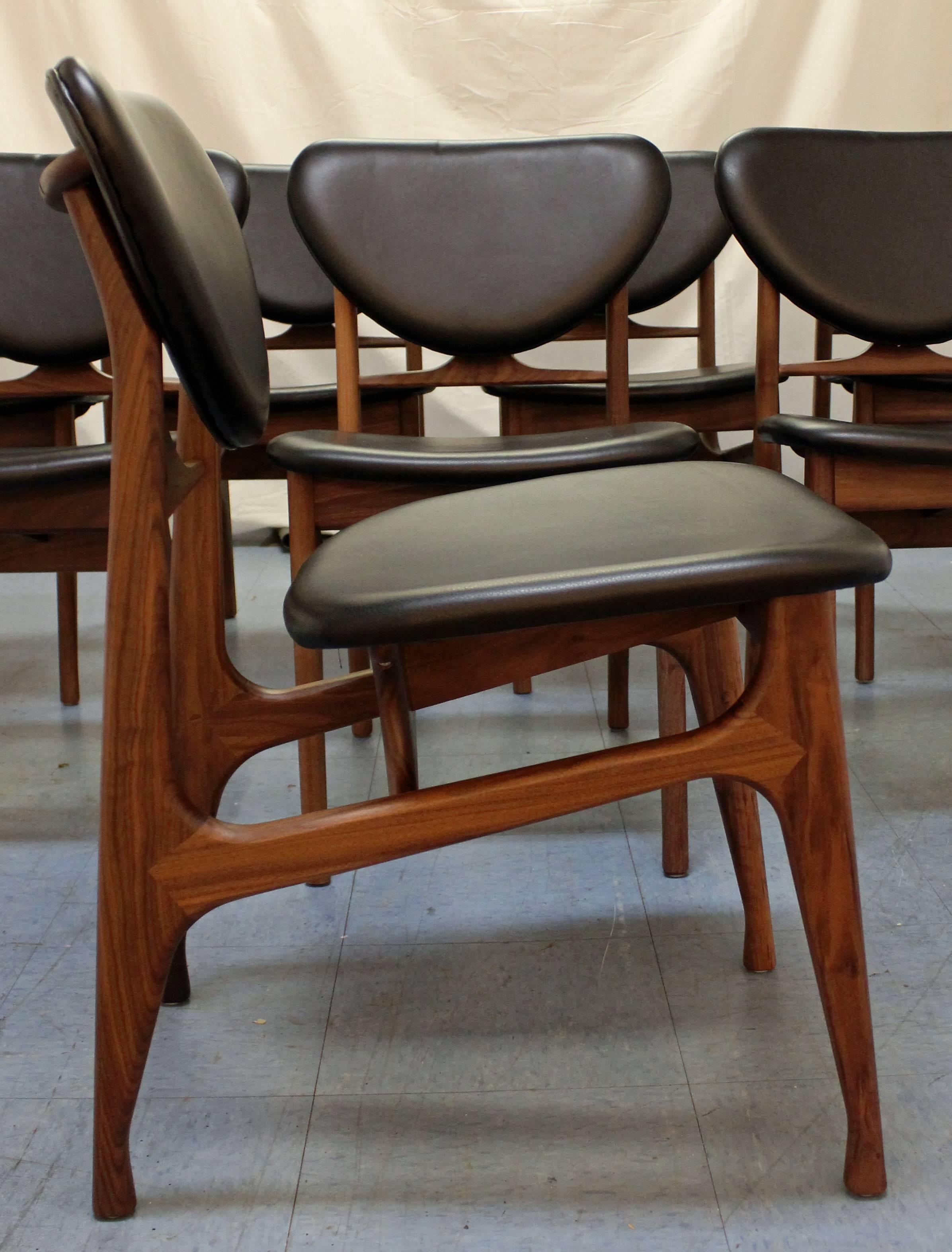 Offered is a set of eight dining chairs Danish Modern Vodder style walnut floating seat dining chairs. The set has great lines and will make a great addition to any room. Includes eight side chairs. They are contemporary reproductions similar in the