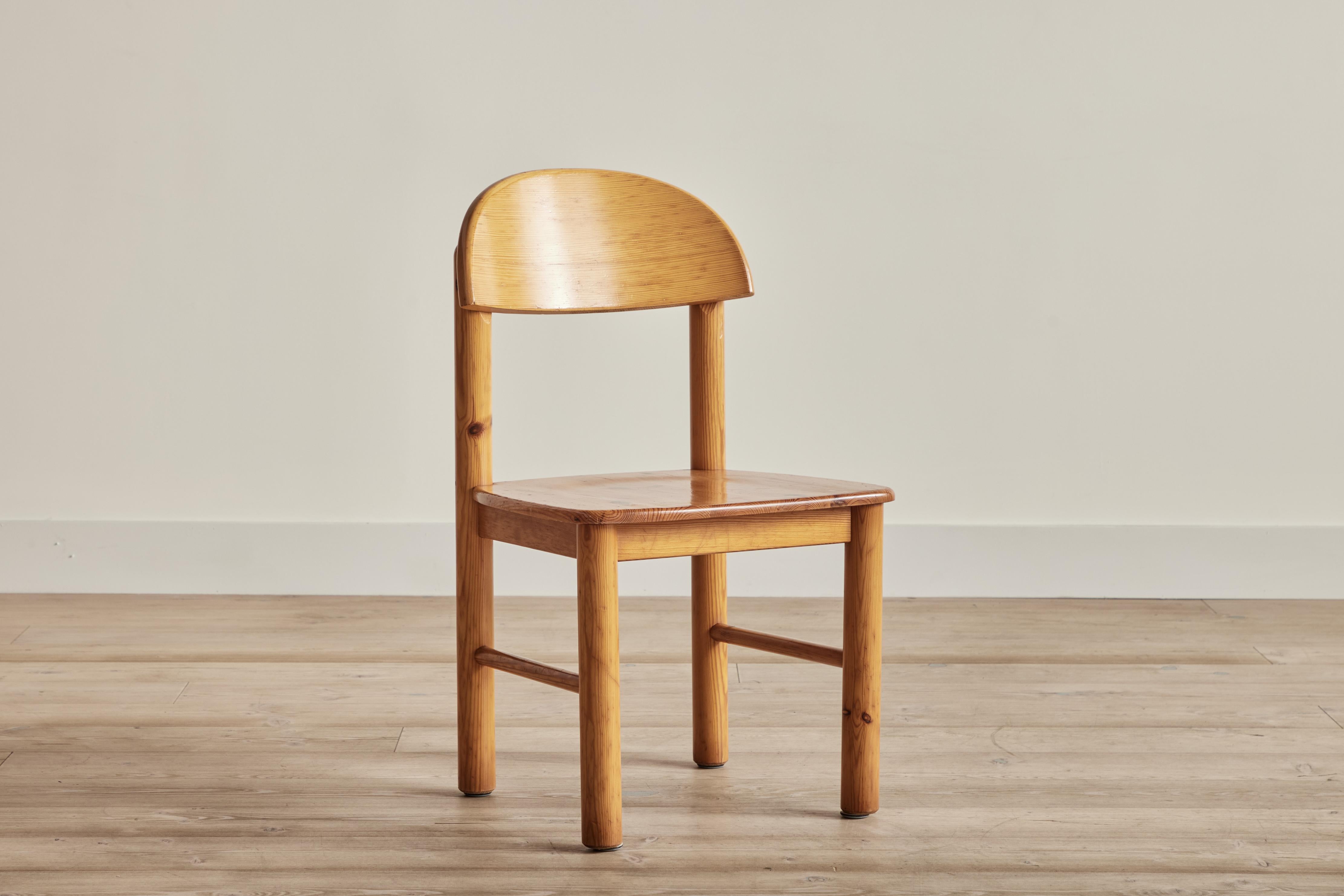 Set of 8 pine wood dining chairs by Rainer Daumiller. Wear on wood is consistent with age and use. 