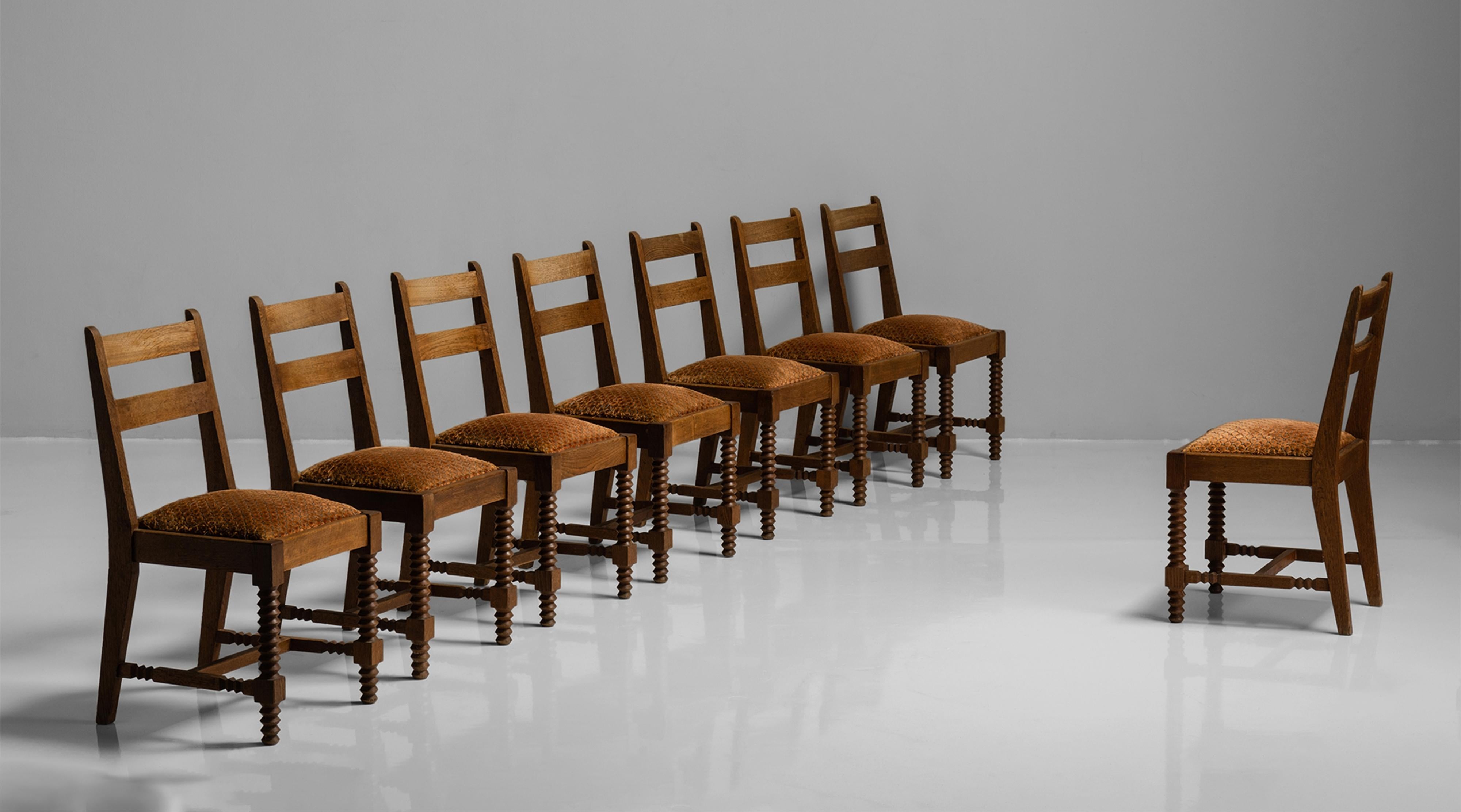 Set of (8) dining chairs attributed to Charles Dudouyt
France, circa 1930

Carved oak frame with original velvet embroidered cushions.

Measures: 17.5