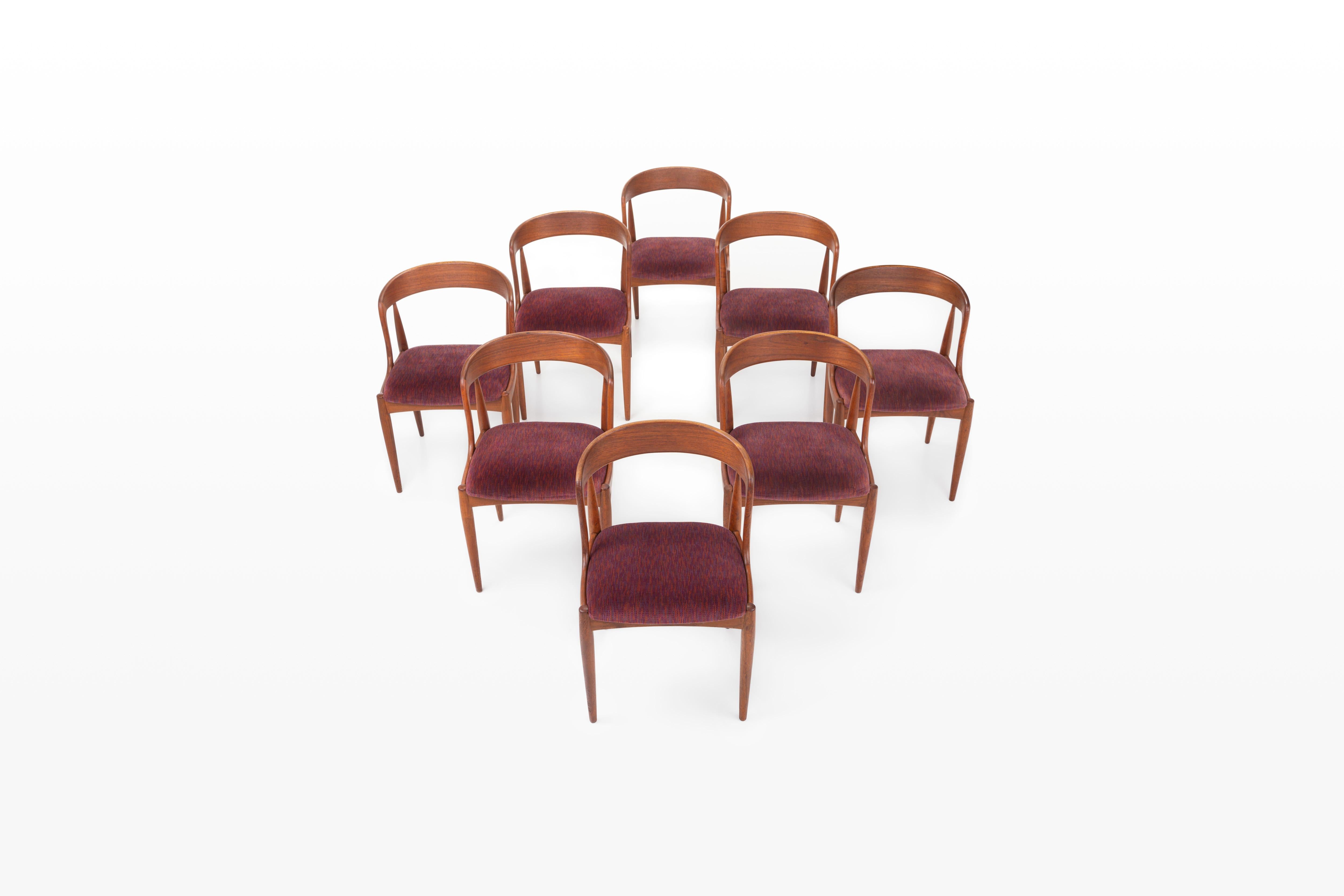 Set of eight vintage dining room chairs. These chairs are designed by Johannes Andersen for Uldum Møbelfabrik in Denmark. They have a teak frame and a red-purple seat. The chairs are in very good condition.

Dimensions:
W: 50 cm
D: 52 cm
H: 74 cm