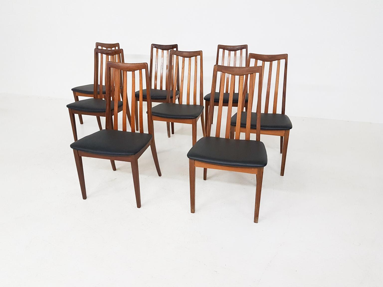 Set of eight dining chairs upholstered in black faux leather by Leslie Dandy for G-Plan, made in England 1960s.

The dining chairs have many similarities with the Eva dining chairs by the Danish designer Niels Koefoed for Koefoeds. This is not a