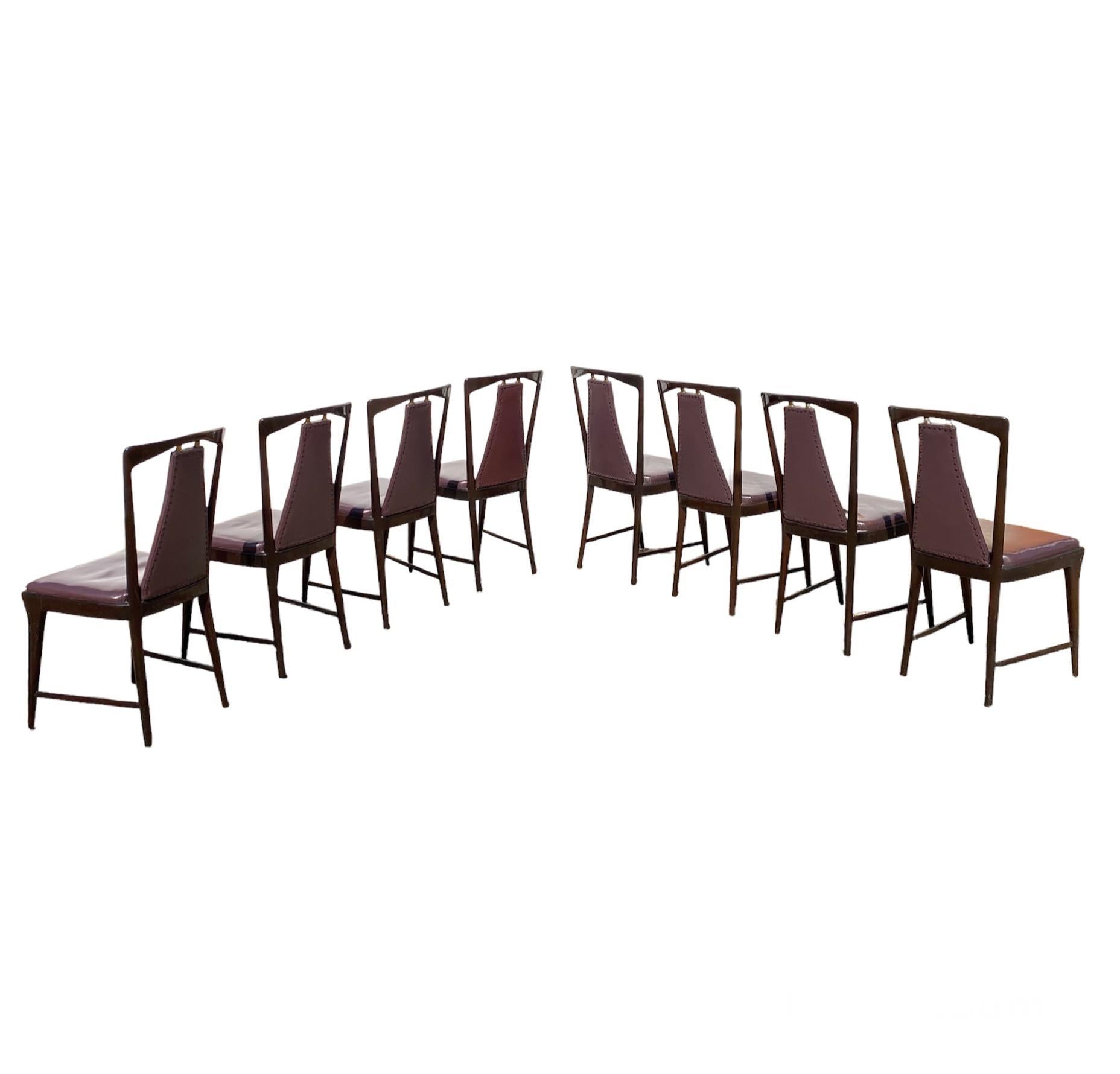 Amazing Set composed of eight iconic Mid-Century style chairs designed by Osvaldo Borsani for Atelier Borsani Varedo, 1940's-1950's
 
The chairs are made in mahogany Beech Wood, with seats upholstered in Purple Skai fabric. 
The structure of the
