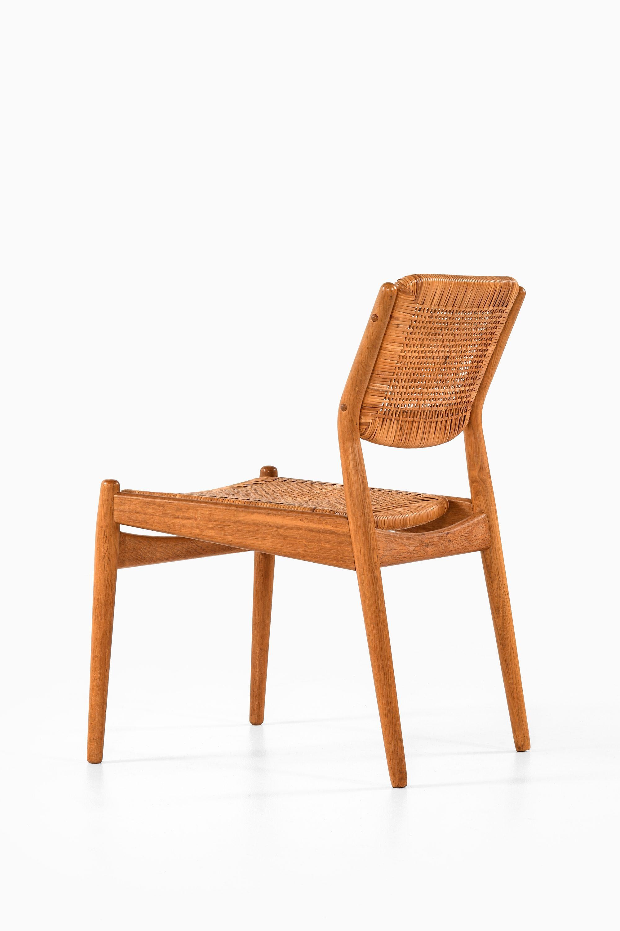 Danish Set of 8 Dining Chairs in Oak and Woven Cane by Arne Vodder, 1951 For Sale