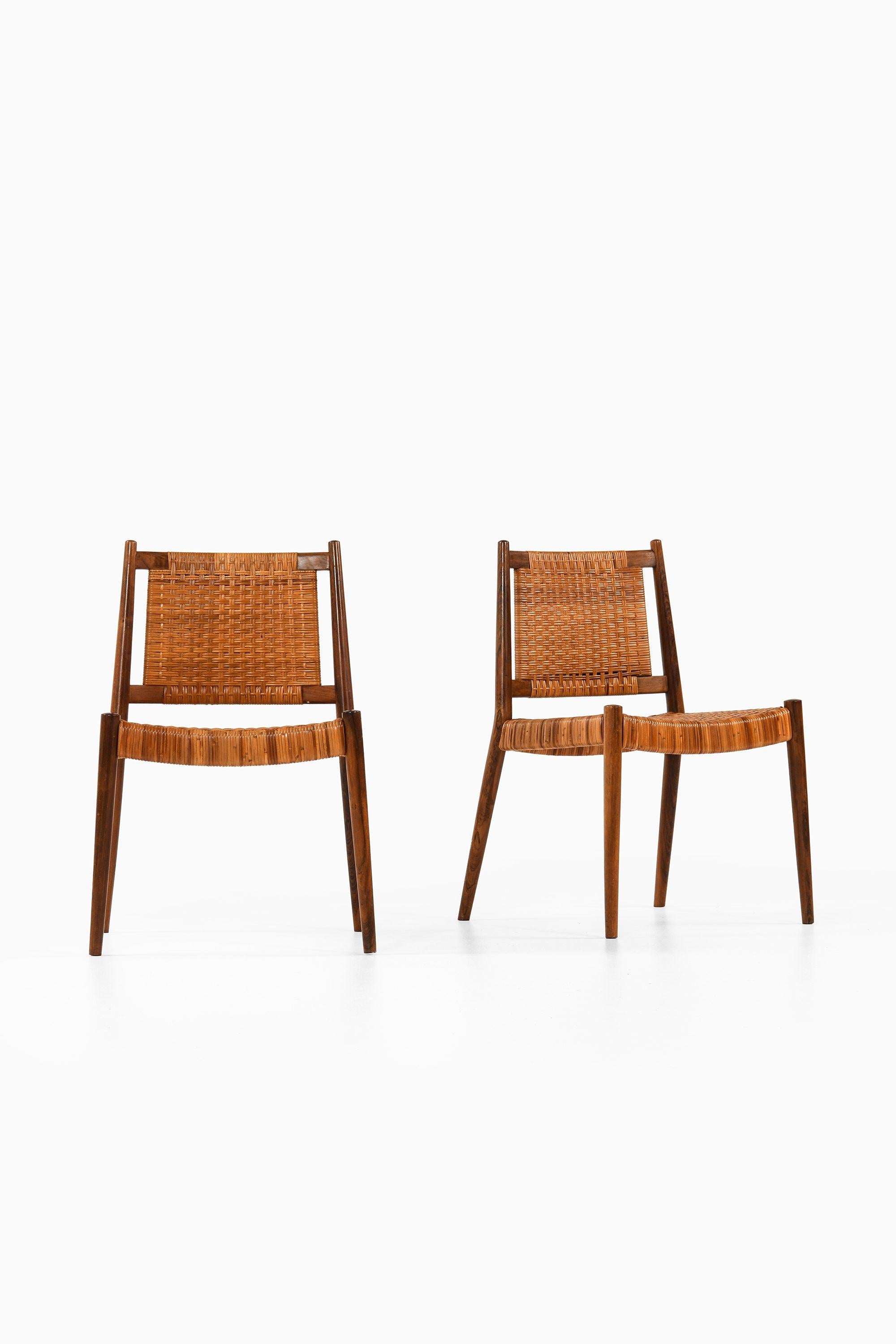 Scandinavian Modern Set of 8 Dining Chairs in Rosewood and Woven Cane by Steffan Syrach-Larsen, 1960 For Sale
