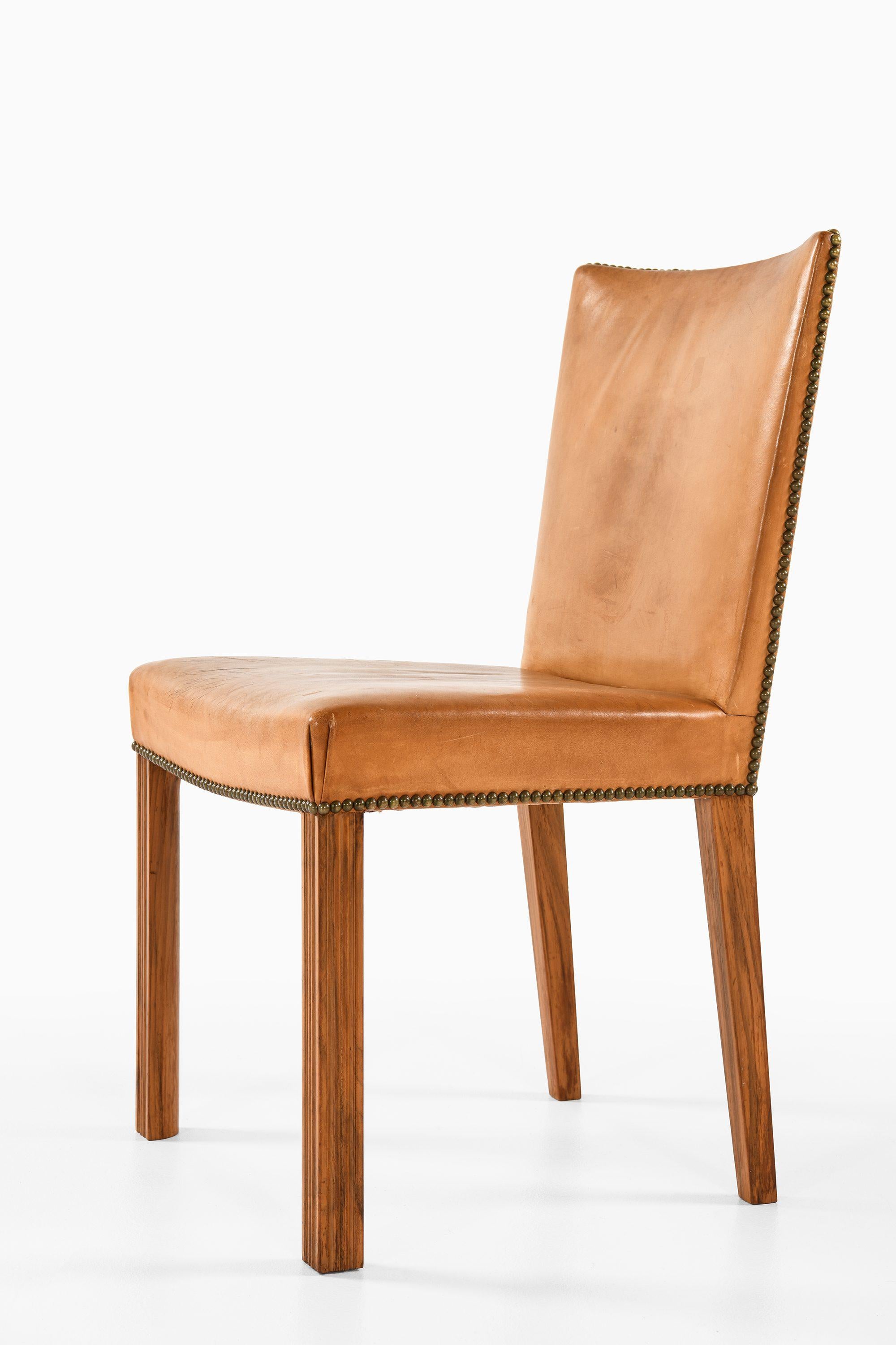 Set of 8 Dining Chairs in Walnut and Brass, 1940s

Additional Information:
Material: Walnut, original leather with brass rivets
Style: midcentury, Scandinavian
Produced in Sweden
Dimensions (W x D x H): 50 x 53 x 88 cm
Seat Height: 46