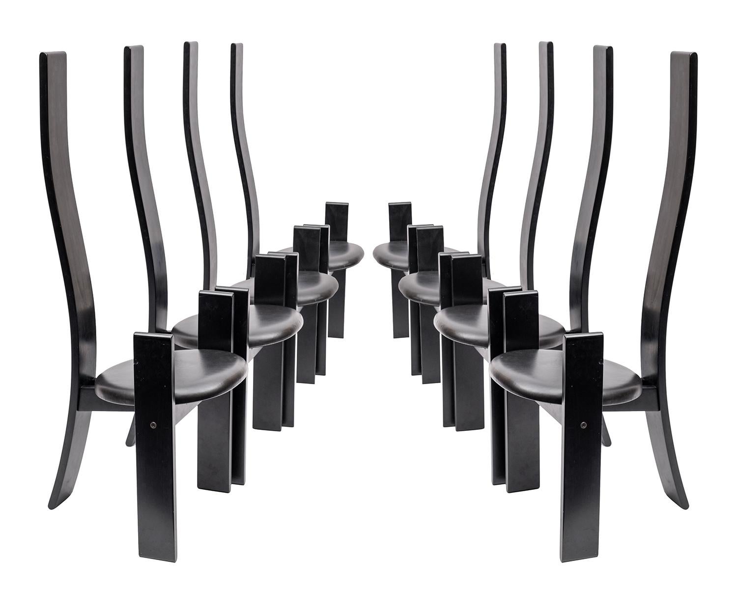 Set of 4 dining chairs model 'Golem' designed by Vico Magistretti for Poggi.

The chairs are made of black lacquered wood and upholstered with black skai.

Beautiful slim and modern design.

Good condition, normal age related wear particularly on