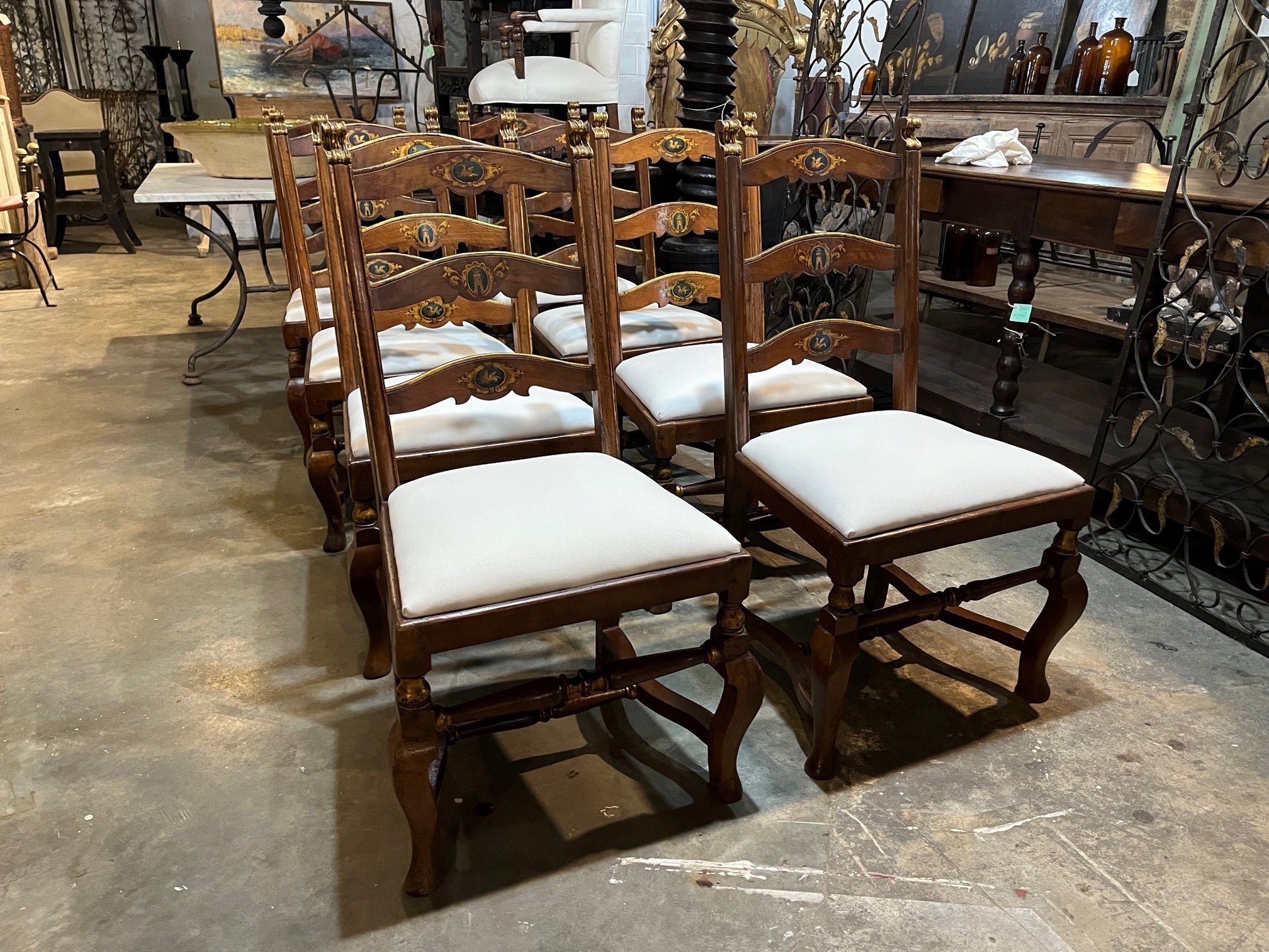 A very handsome set of 8 early 18th century Dining Chairs from the Lombardy region of Italy.  Wonderfully constructed from walnut with gilt and painted detail.  The seat cushions have recently been reupholstered and remove easily.  The seat height
