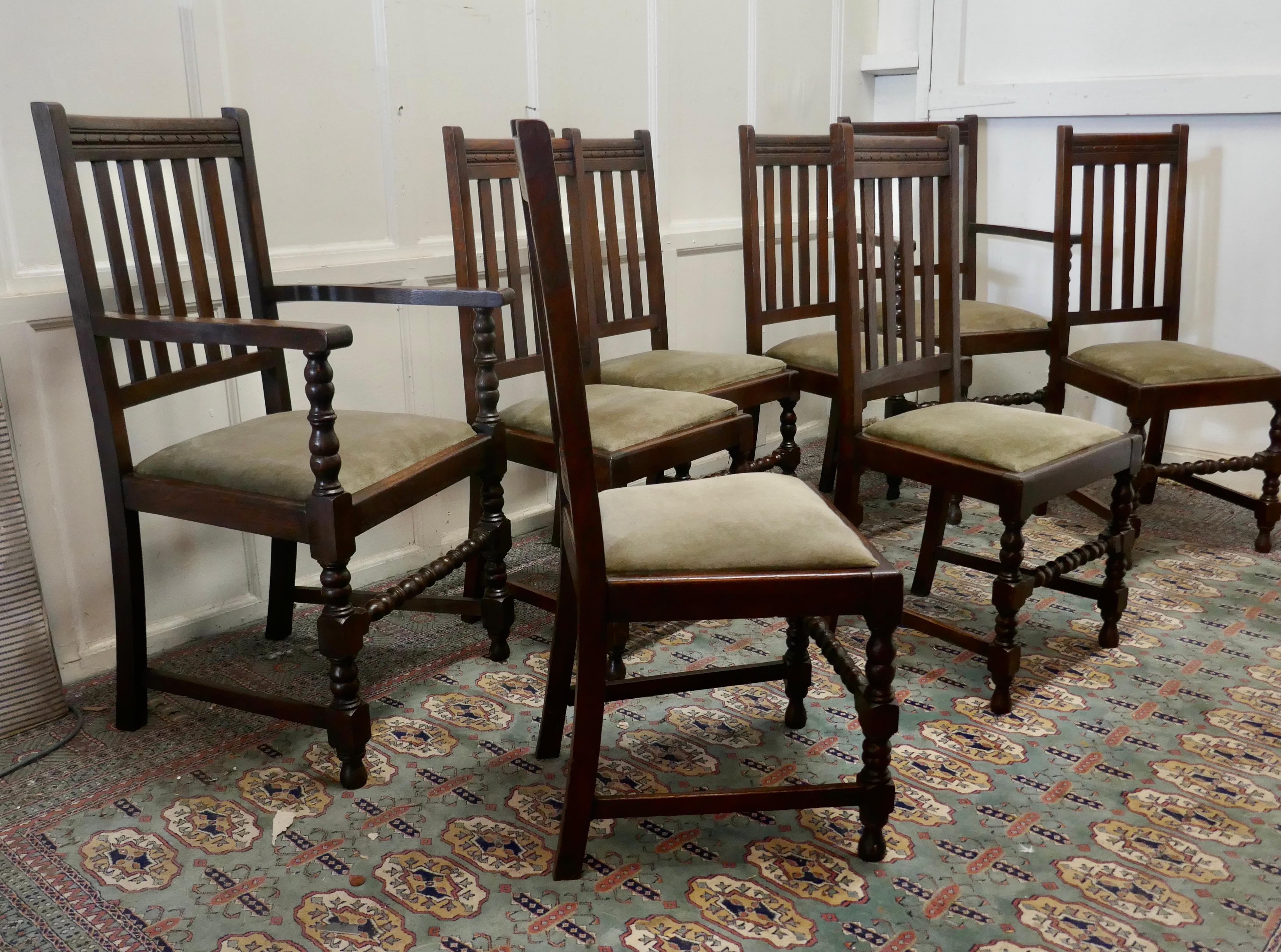 Set of 8 early 20th century country oak dining chairs 

This is a very handsome set of high back country oak chairs, 2 are carver chairs,
the oak frames have turned legs and stretchers and the backs have slats under a decorative moulded top rail.