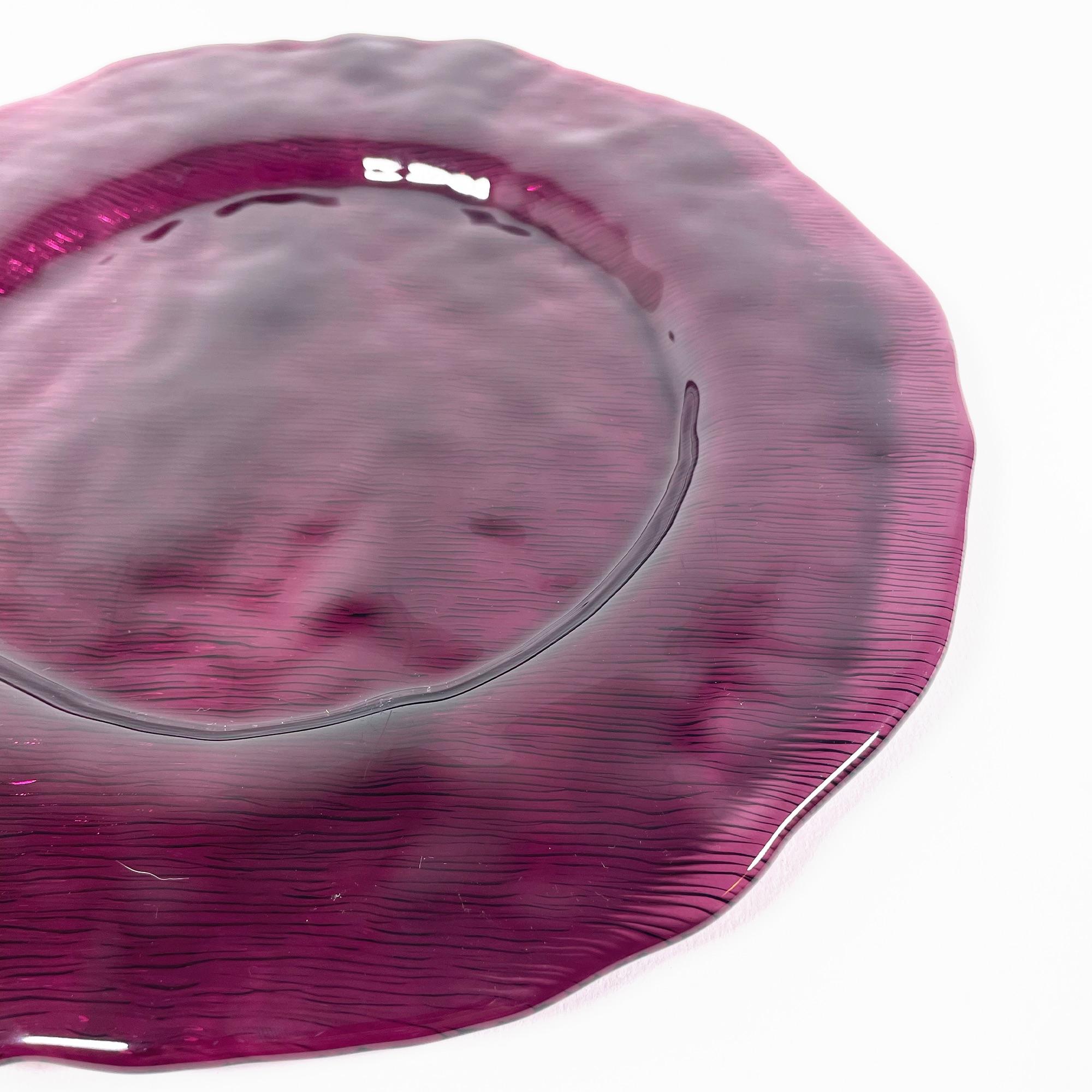 Transform your dining experience with this stunning set of 8 violet glass plates from the early 2000s. Crafted with precision and elegance, these plates exude a contemporary charm that is sure to impress your guests. The rich violet hue adds a pop