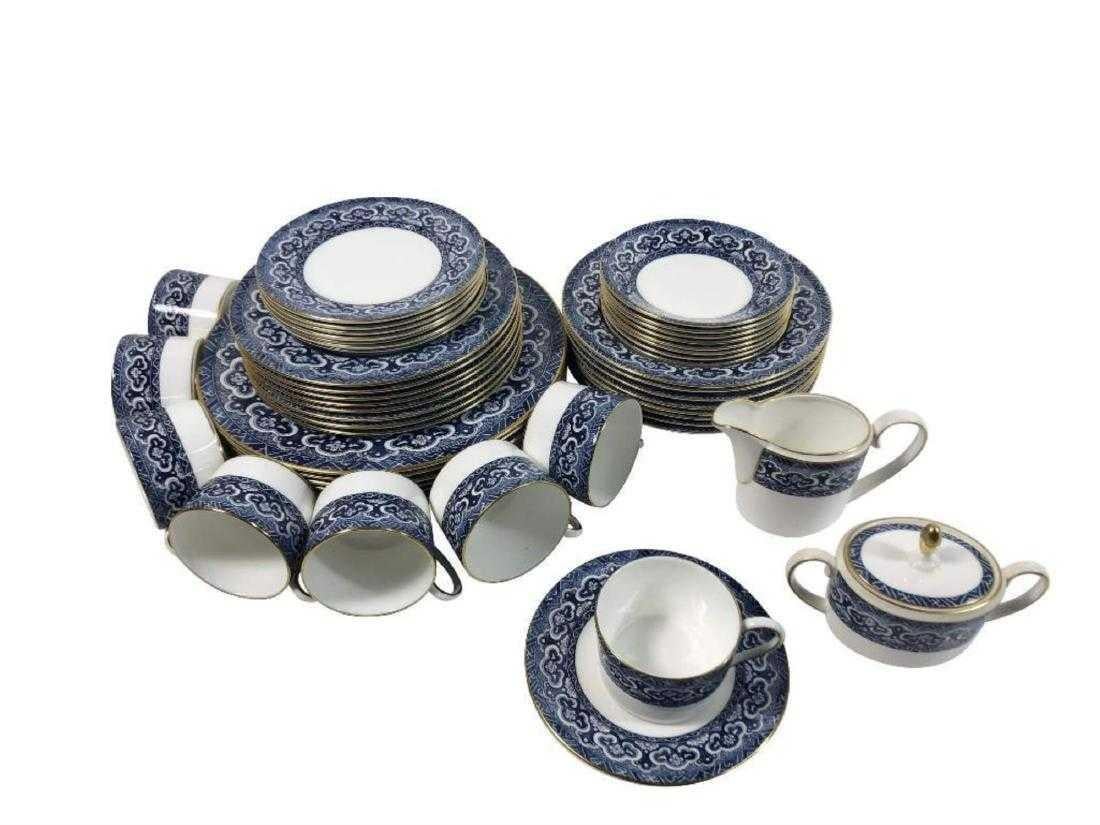 A 20 piece set of four (4) place settings in the Empire pattern made by Wedgwood for Ralph Lauren Home. England, circa 1990.

Features a vibrant blue and white pattern with gold rim. This pattern has since been discontinued.

Set includes the