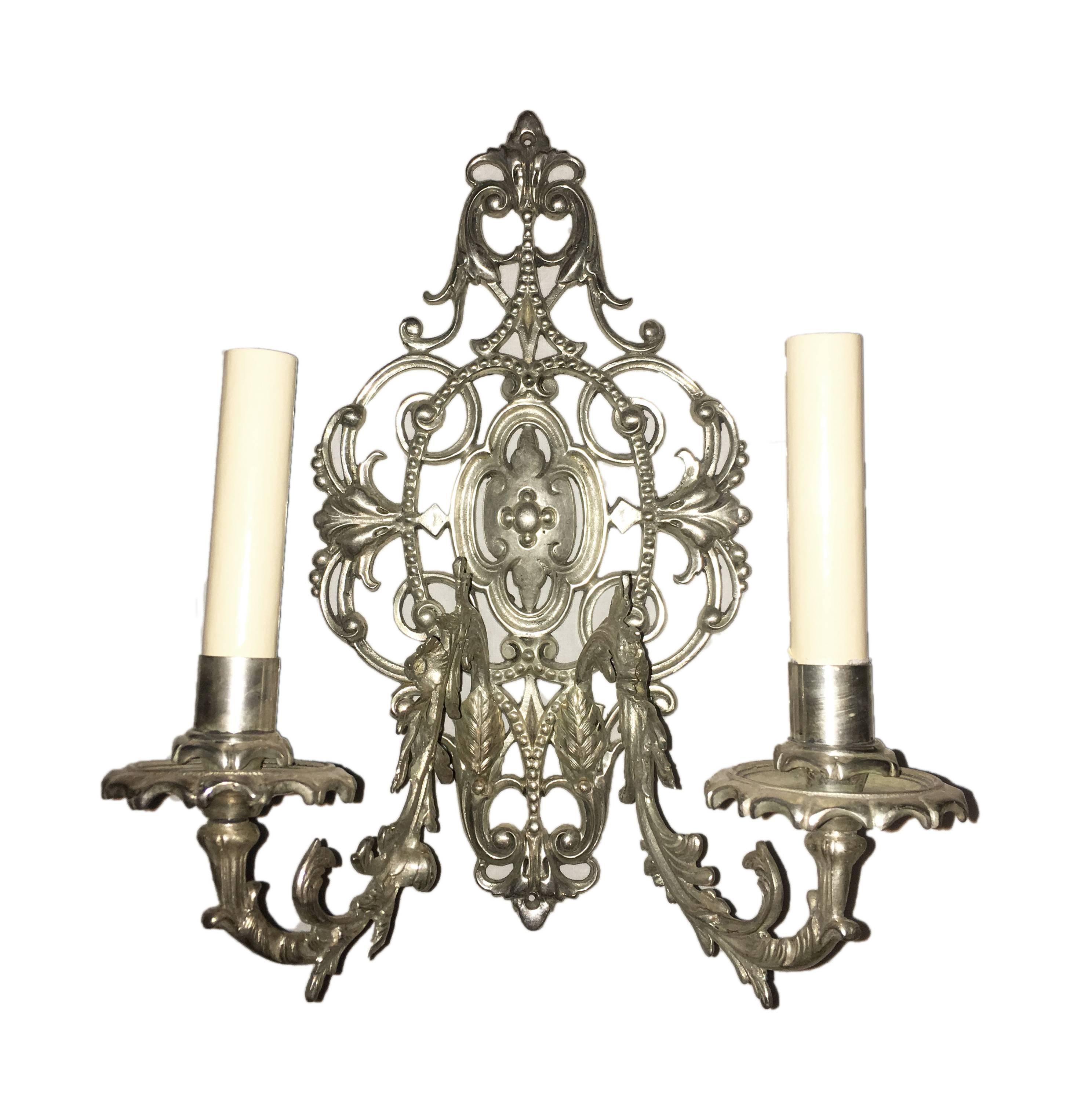 A set of eight circa 1920's English cast bronze sconces with a silver plated finish, foliage motif and original patina. Sold per pair.

Measurements:
Height: 14