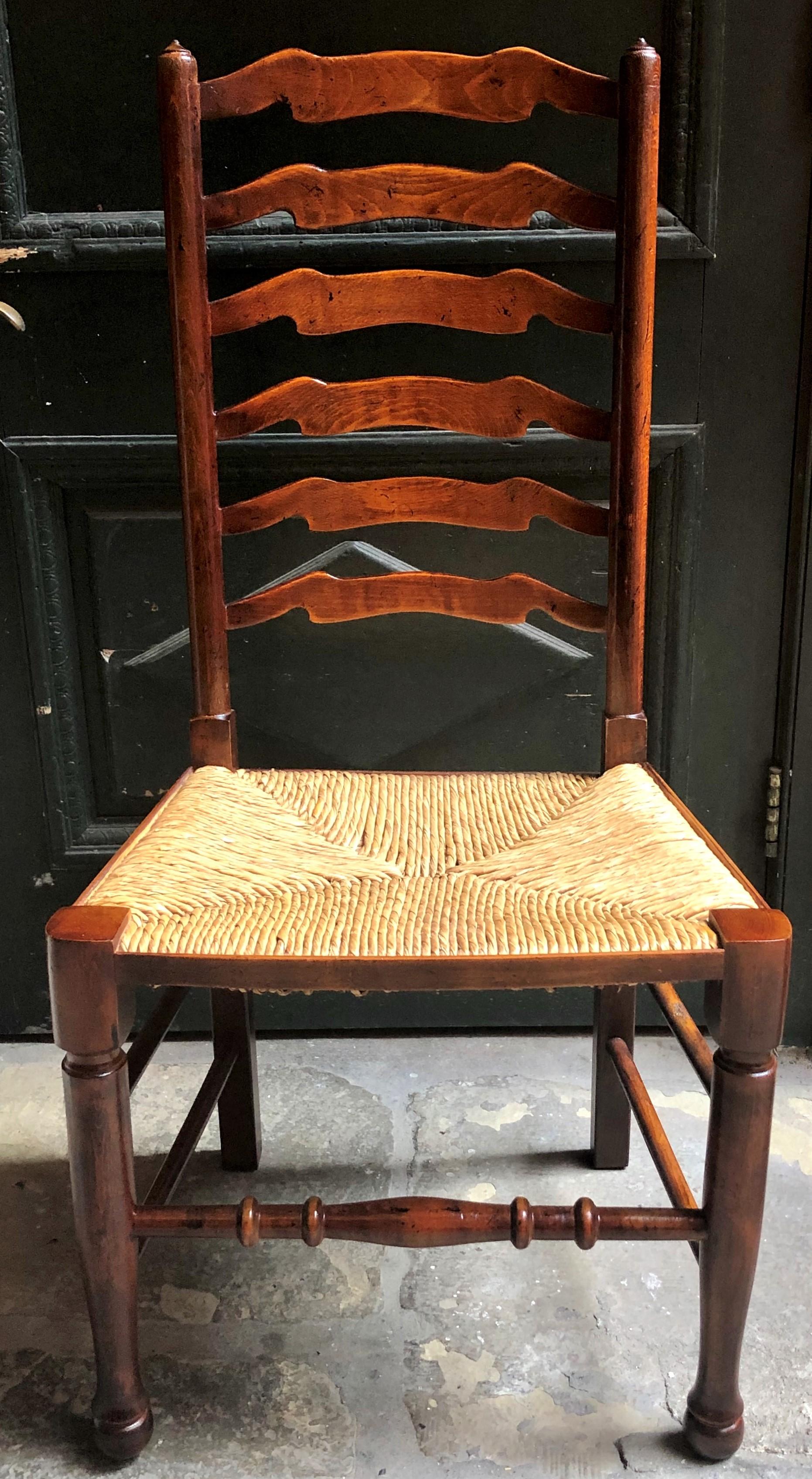 Set of 8 estate English ladder back chairs with rush seats, circa 1940.
6 side chairs and 2 armchairs.
