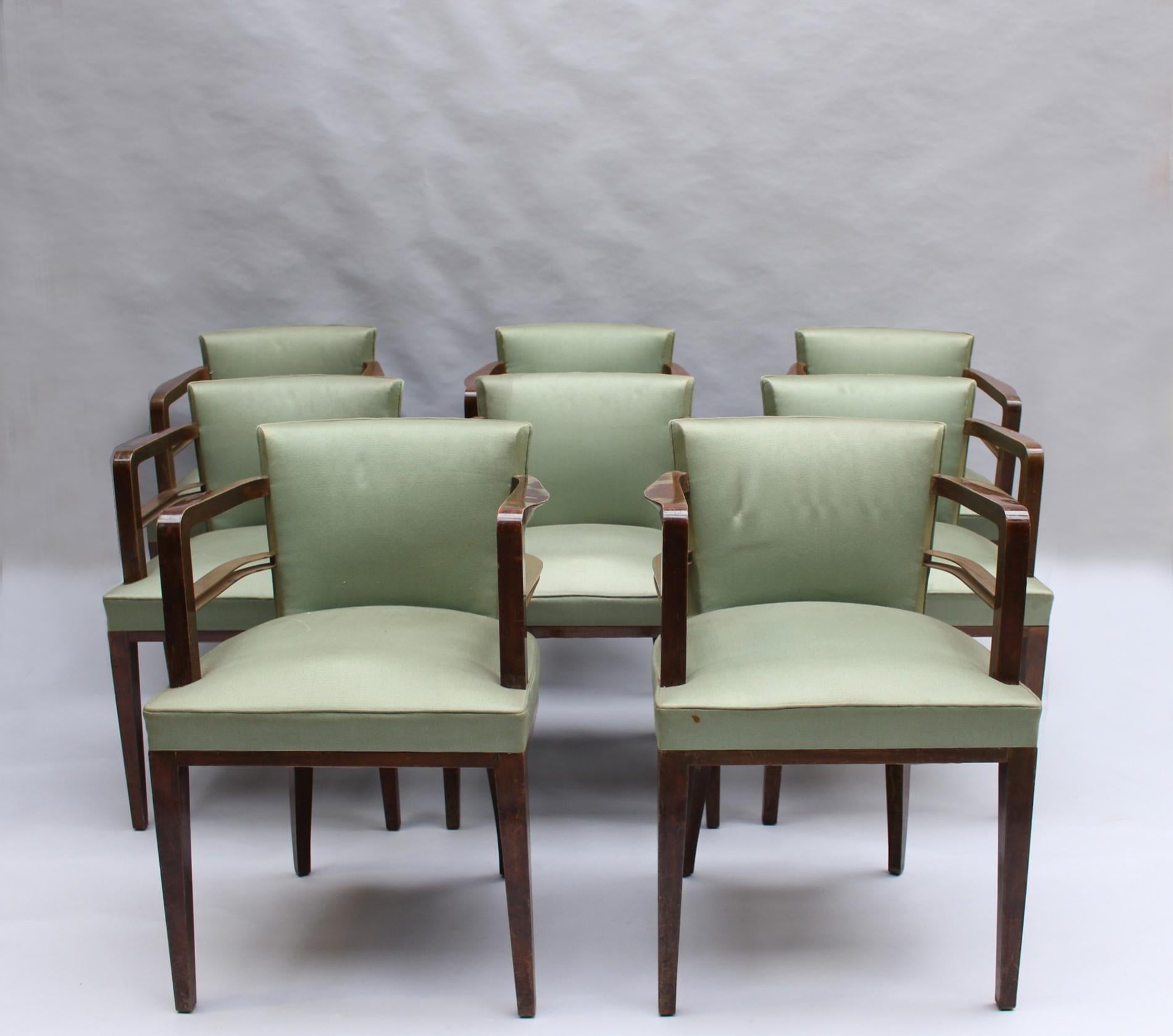Jean Pascaud - A set of eight fine French Art Deco dining / side chairs in stained wood adorned with brass arm supports.
Documented in the magazine 
