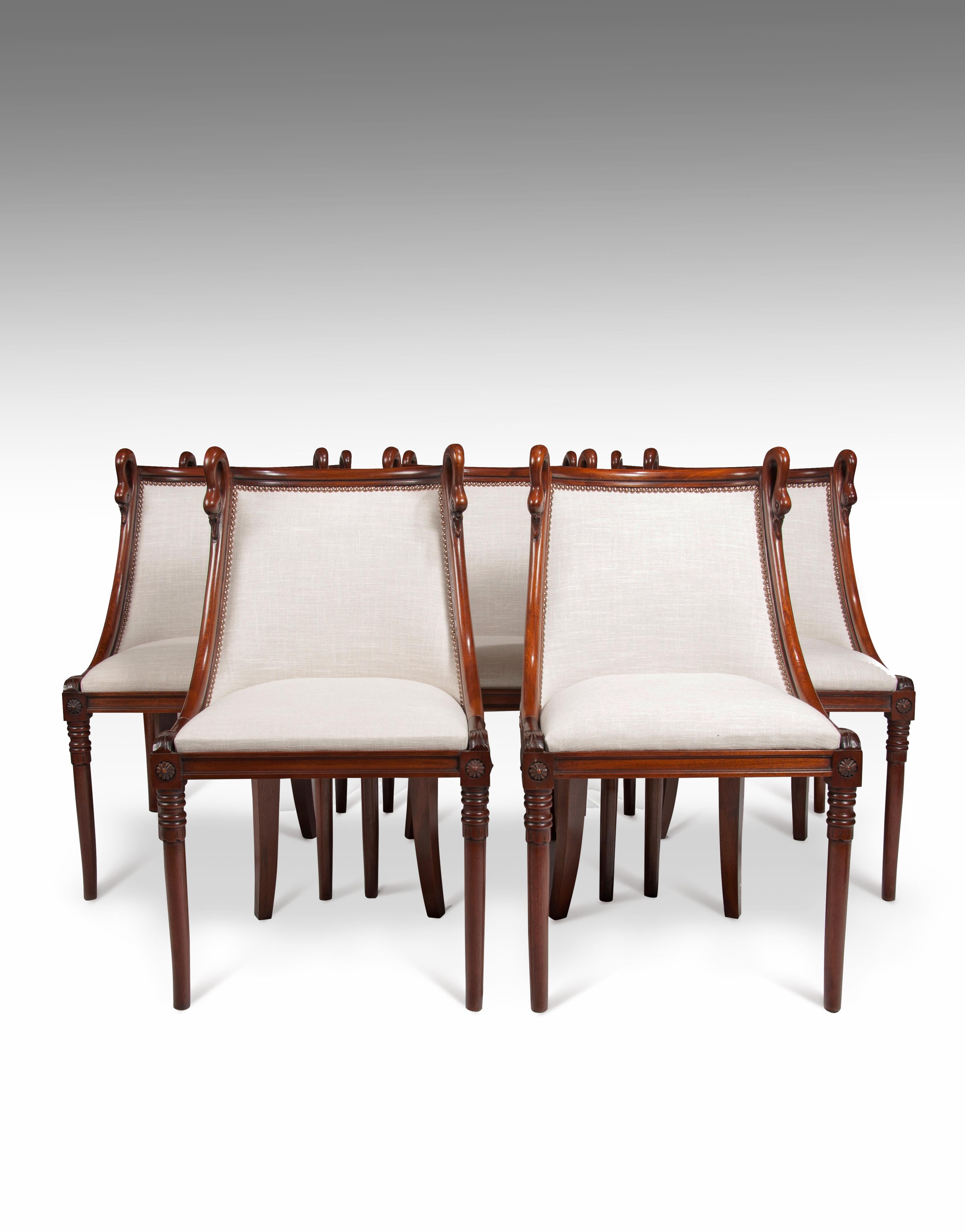 A charming set of 8 French 19th century Empire style barrel back mahogany dining chairs.

French, circa 1880.

Constructed of solid mahogany with a French Empire influence, the sweeping curved barrel backs being flanked by carved swan