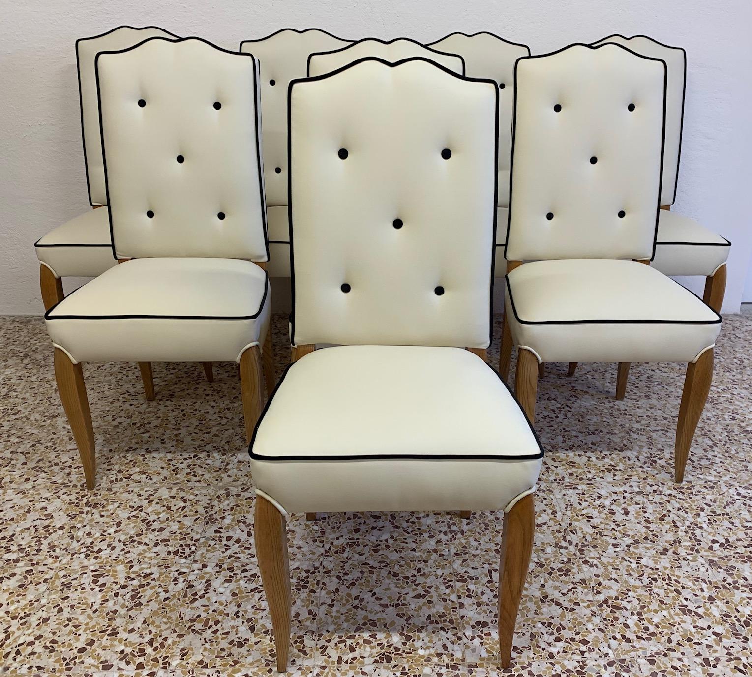 This set of 8 Art Deco chairs were produced in France in the 1930s.
The chairs have been upholstered in precious ivory leatherette while the edges and buttons in black velvet.
The wooden part is in solid Durmast.