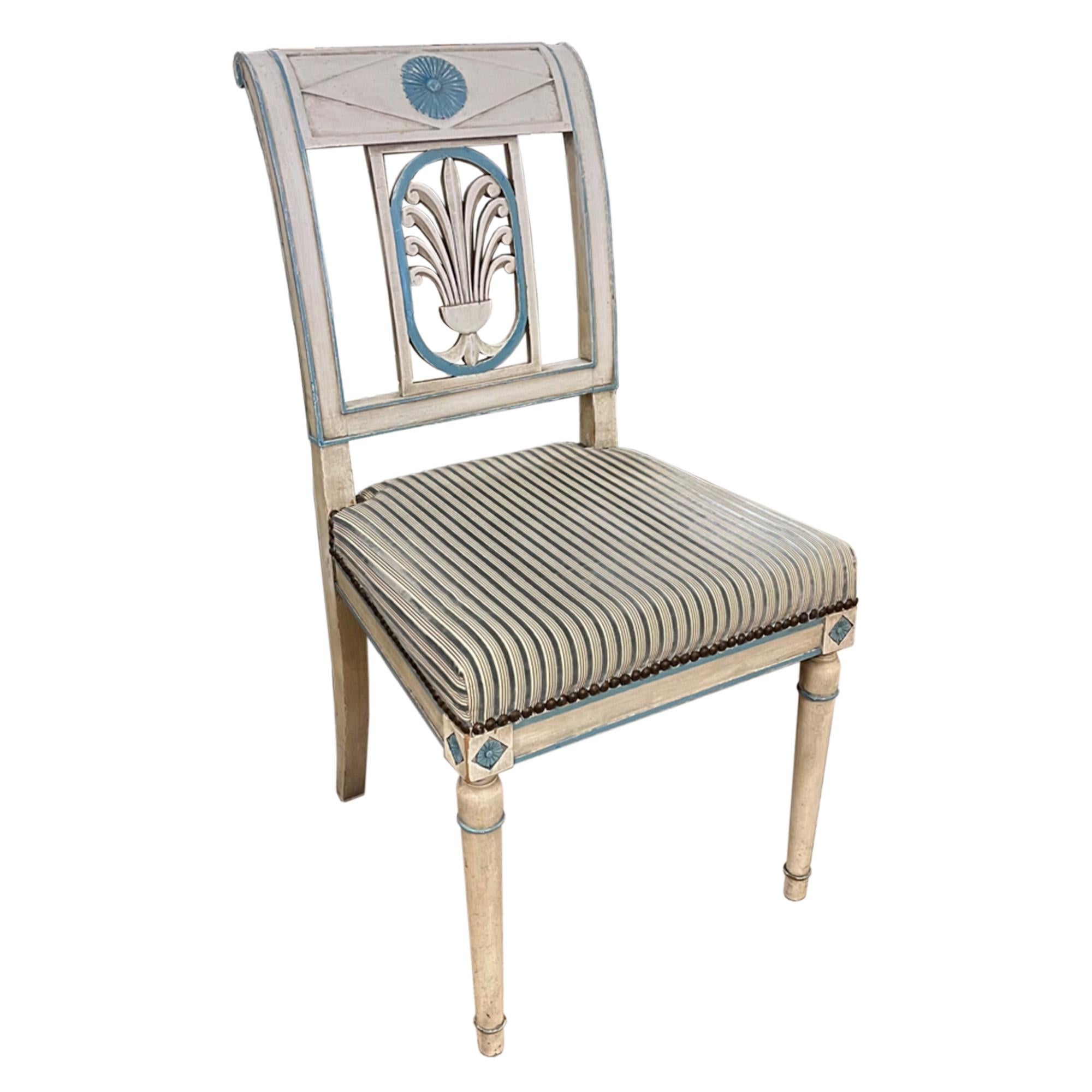 This is a very decorative set of French dining chairs. 

The attractive directoire design is accentuated with the original cream and pale blue original paint. Please take a look at all our pictures to see the floral and swirl decorations. The