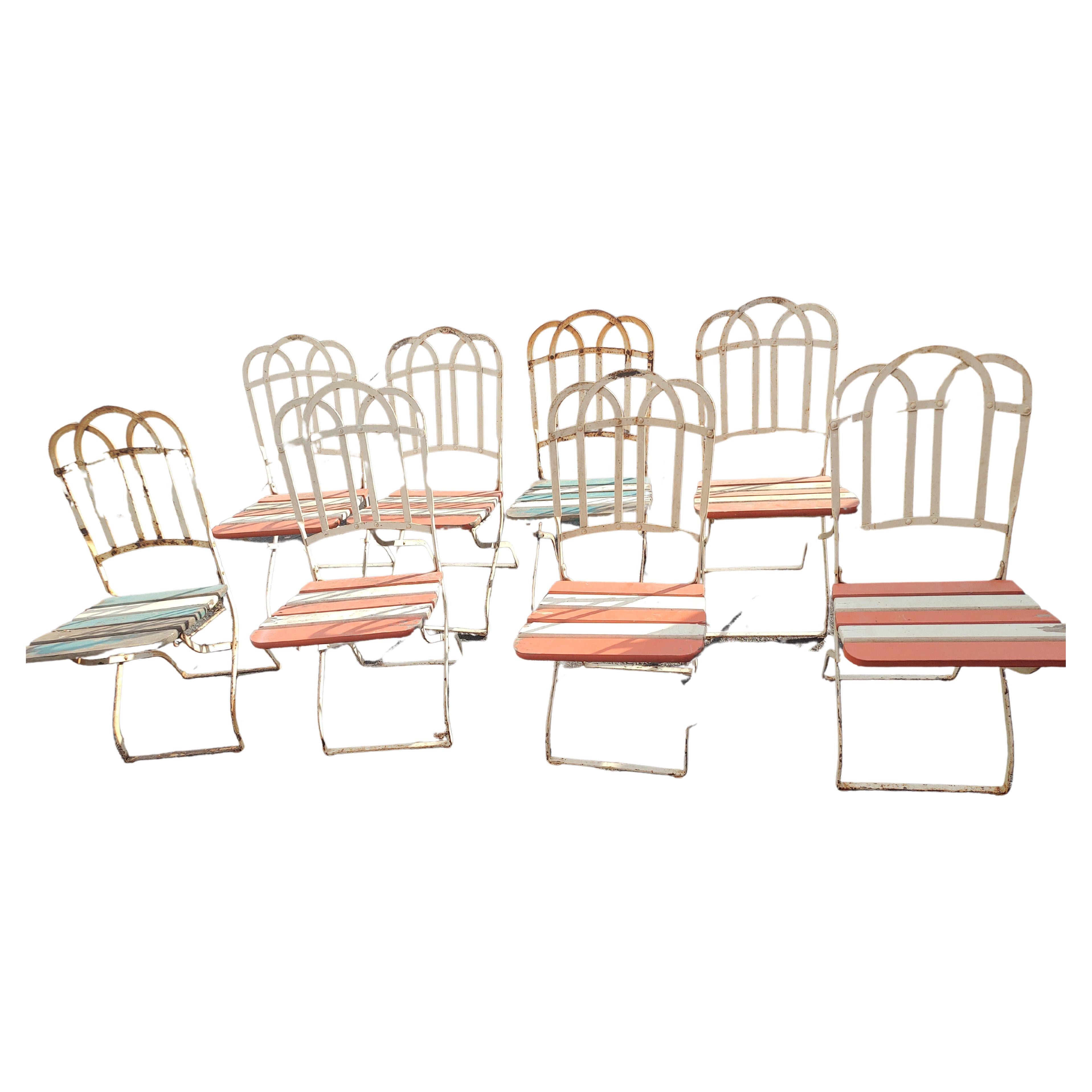 Fabulous set of 8 fold up garden dining area chairs with a bit of that Parisian charm and elegance associated with French Cafes. Chairs are in excellent antique unrestored condition. Wood is totally intact and the fold up mechanisms work great. Old
