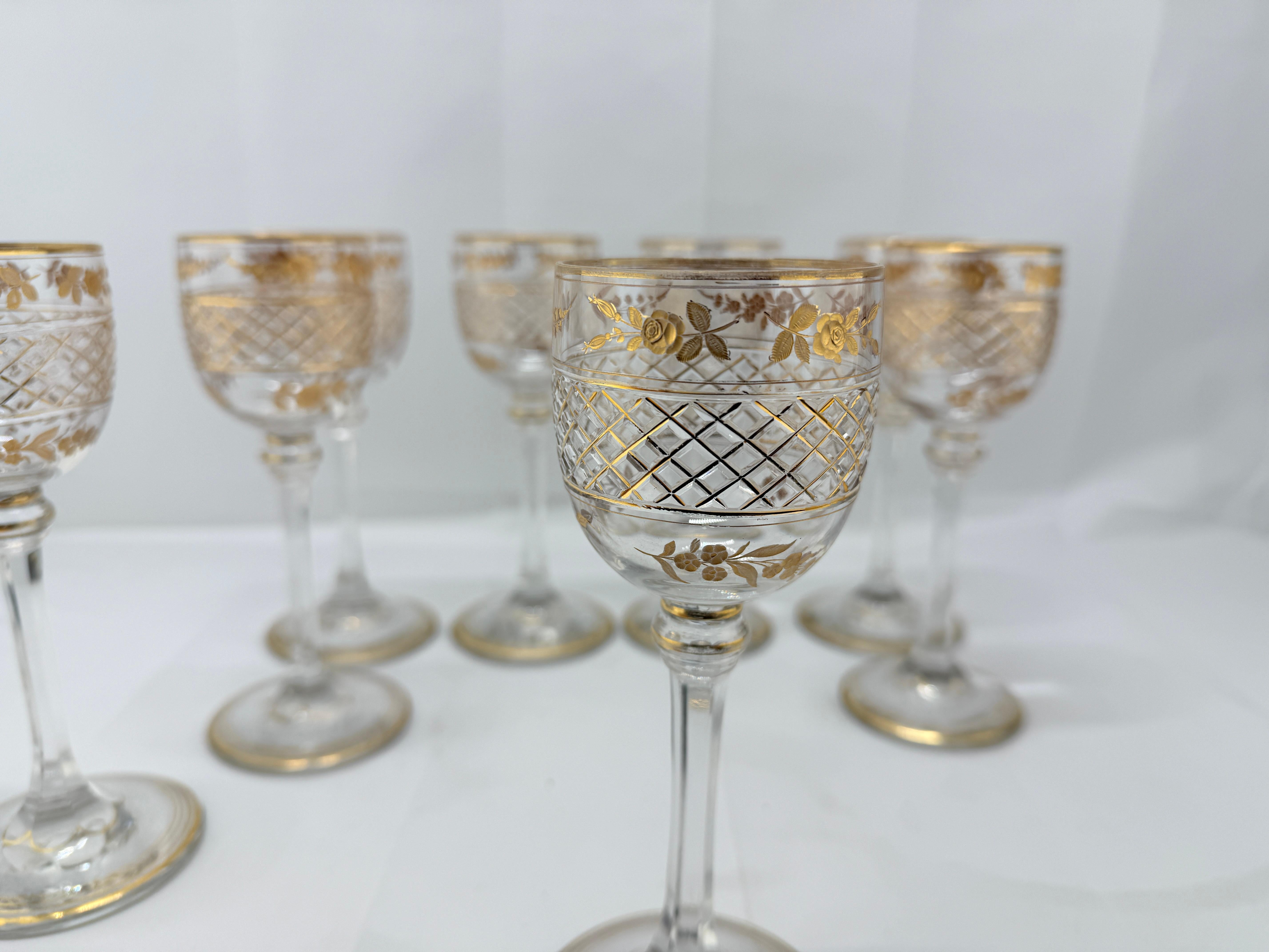 This exquisite set of eight antique wine goblets, crafted in France, exemplifies refined 19th-century glassmaking. Each goblet showcases an elegant combination of artistry and craftsmanship, featuring a gilded rim and delicate rose and floral motifs