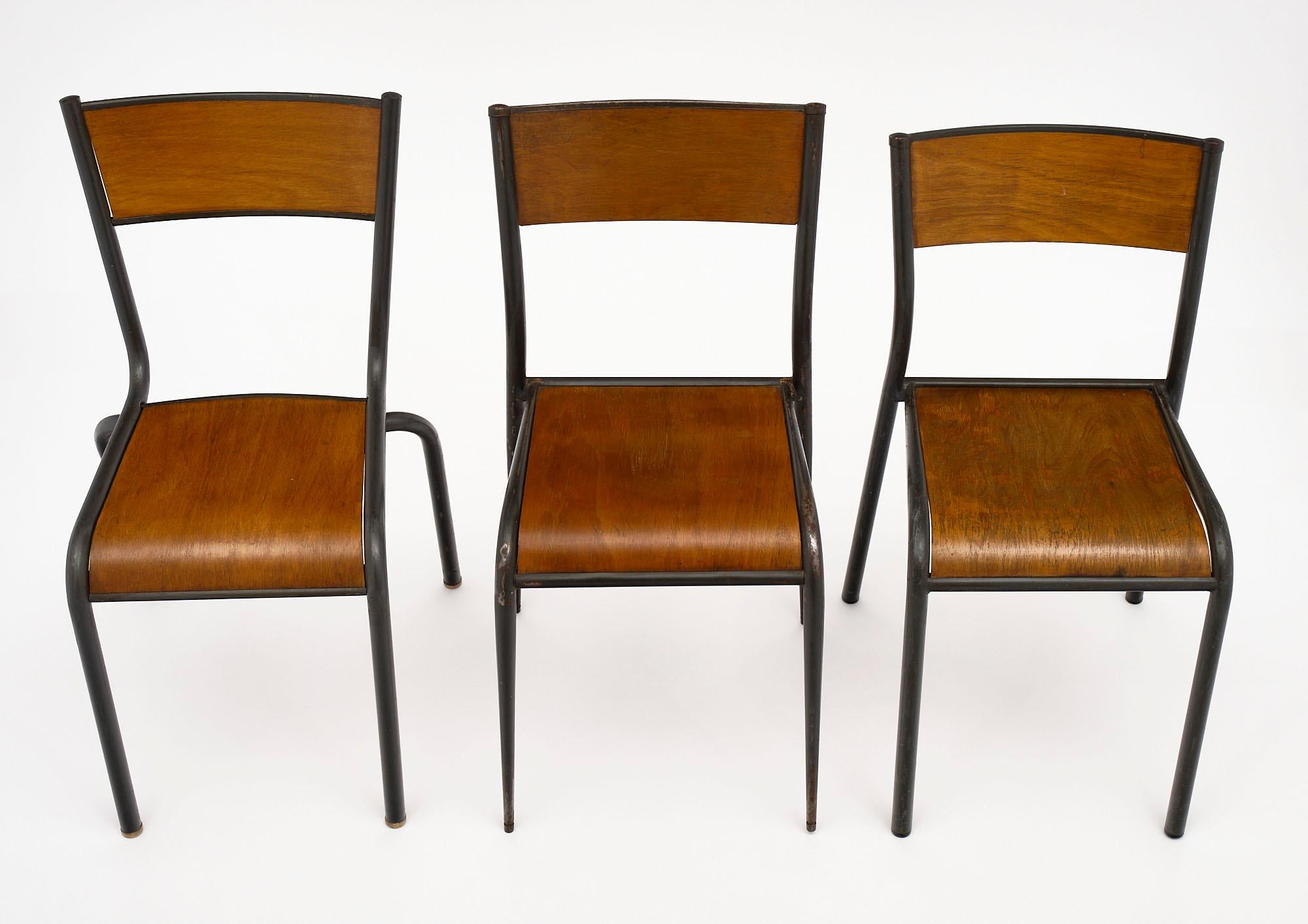 Set of 8 French industrial chairs from a silk manufacturer in the Lyon region. They feature the original painted steel and formed beech wood. The chairs are not identical, there are several different distinctive details for this superb set (shown in