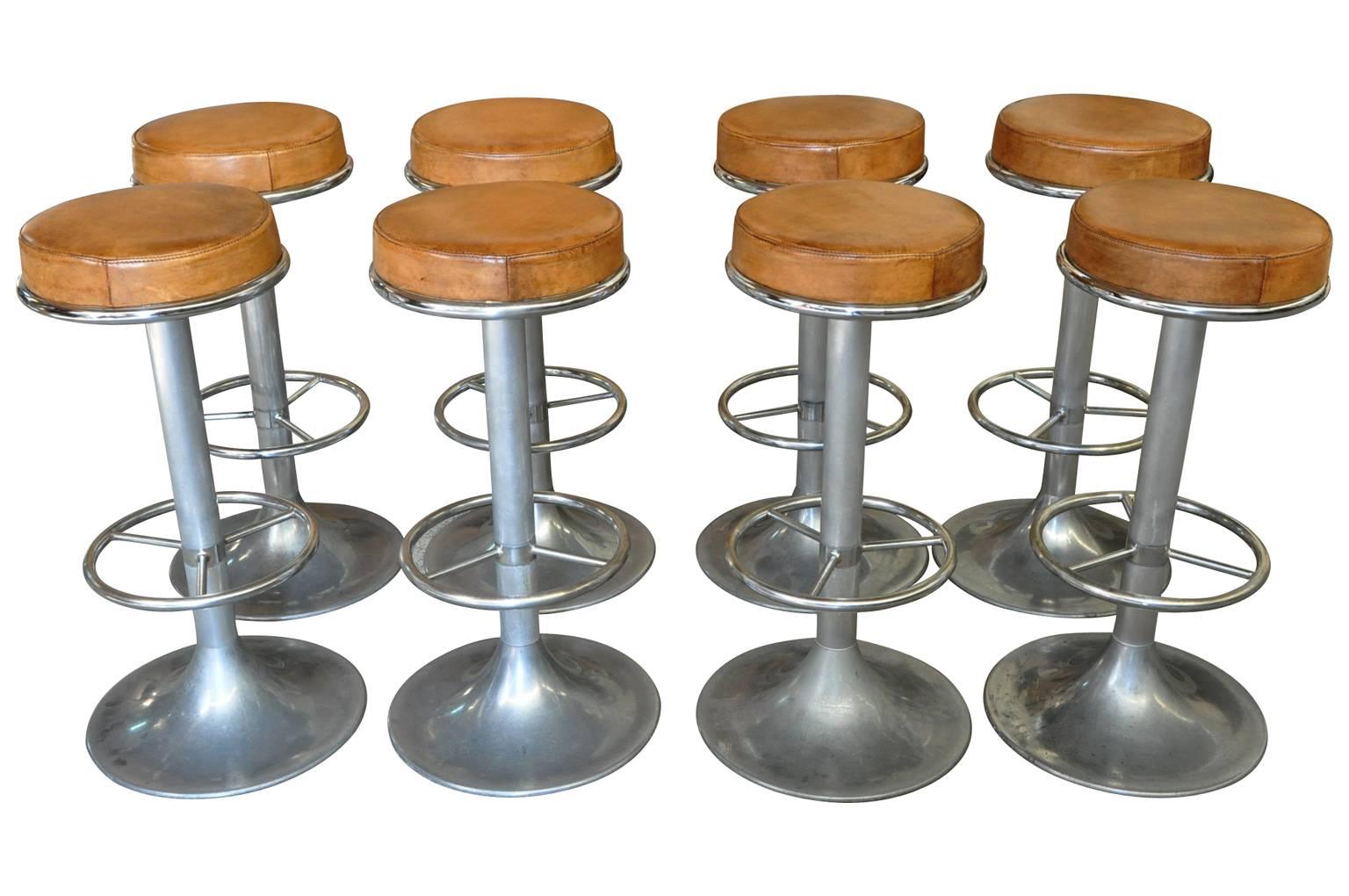 A terrific set of eight midcentury bar stools from France. Wonderfully and soundly constructed from brush and chromed aluminum and leather.