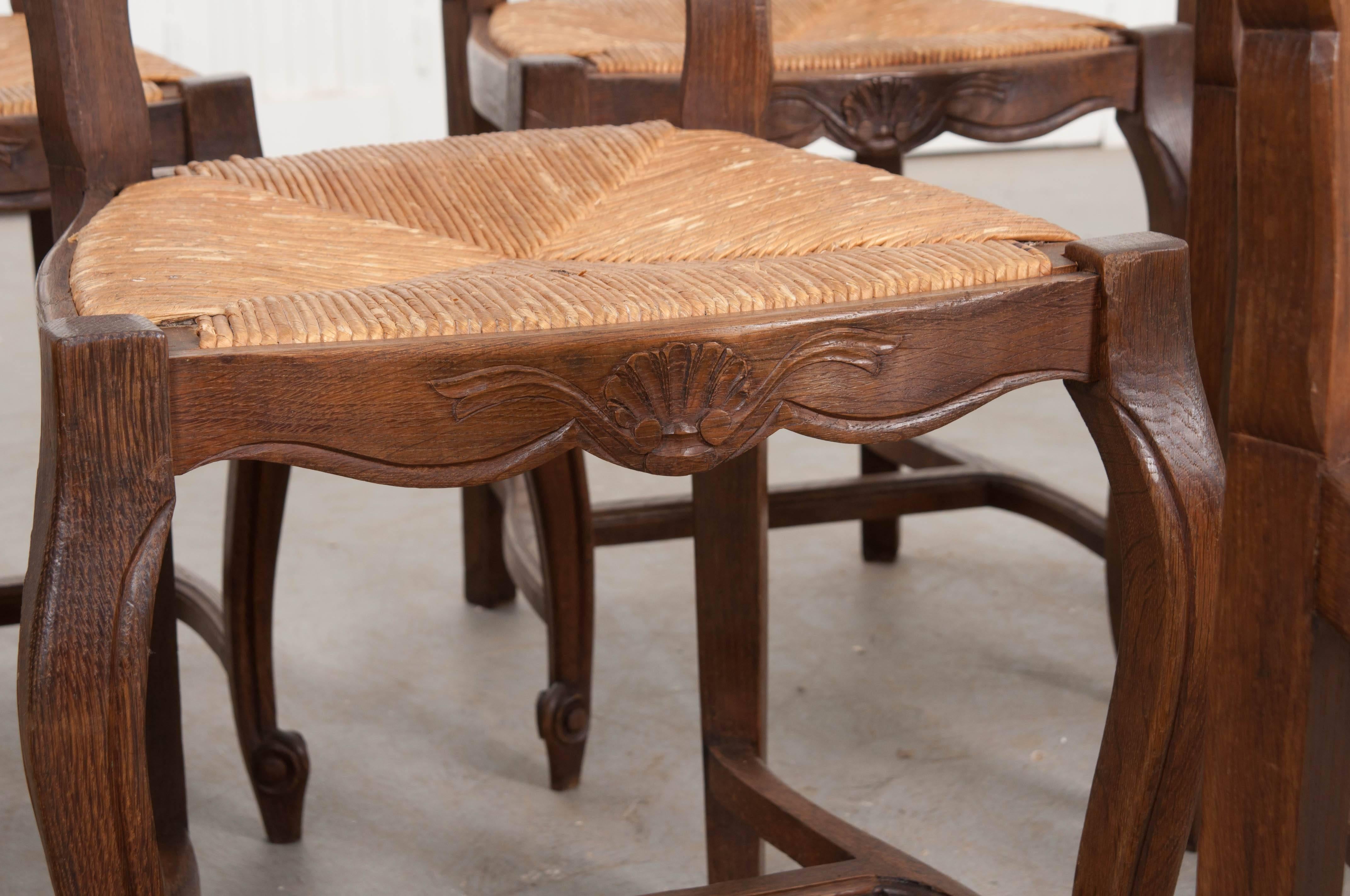 Carved Set of Eight French Oak Ladder Back Chairs with Rush Seats