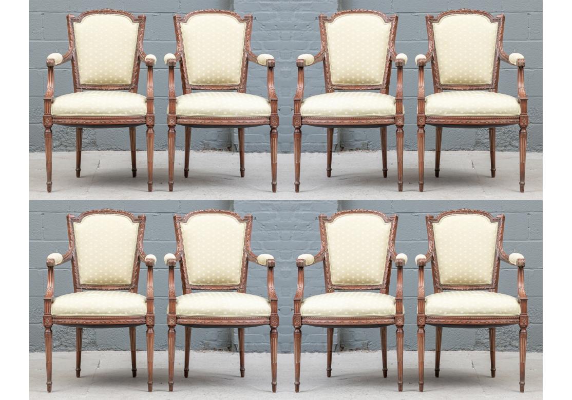 A delicately carved set of eight dining chairs in the Provincial French or Napoleon III style with quality carved wood frames. Overall ribbon twist frames, the shaped crest rails with center bows. Carved acanthus leaves on the arm ends and supports,