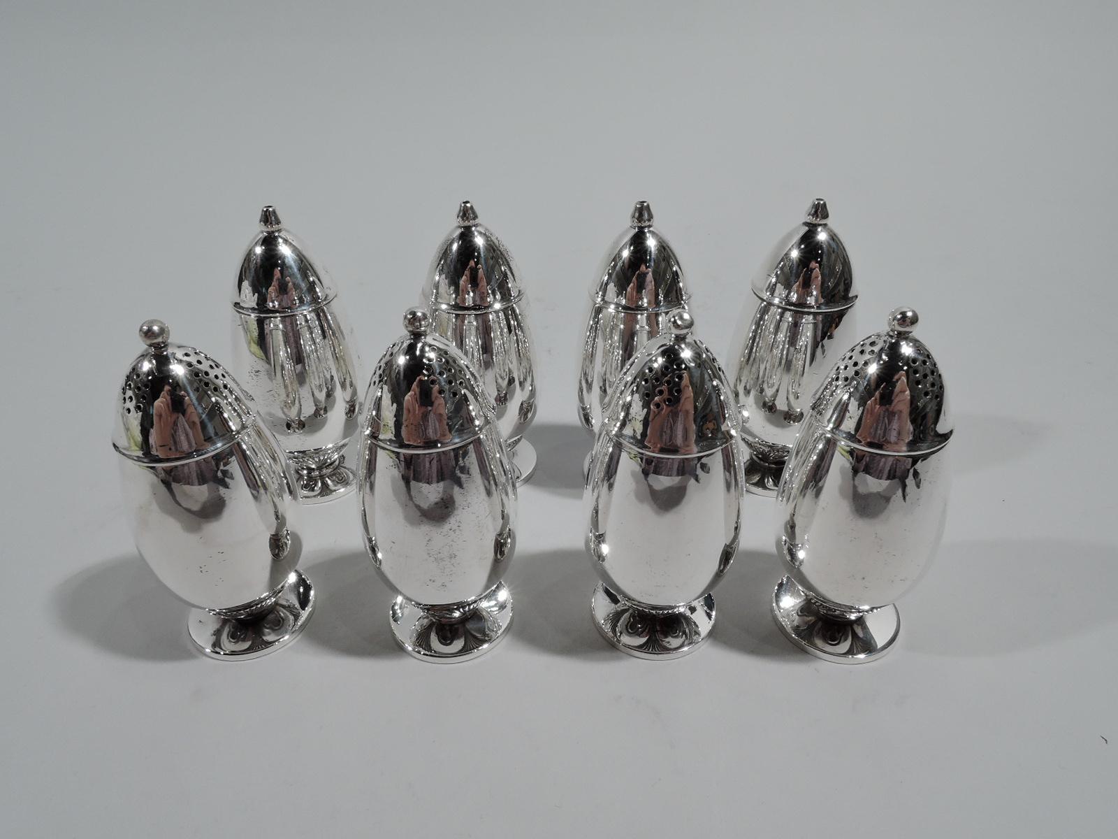 Set of 8 Cactus sterling silver salt & pepper shakers. Made by Georg Jensen in Copenhagen. Each: Ovoid body on raised round foot. Four shakers have pierced cover with bead finial. The other four have single central spout. The cactus motif is tucked