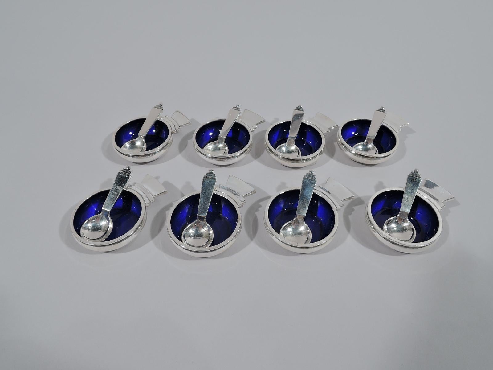Set of 8 sterling silver open salts and spoons in Pyramid. Made by Georg Jensen in Copenhagen.

Each salt: Shallow and curved bowl with capital-style handle. Interior lined with cobalt enamel. Each spoon: Round bowl and straight and tapering