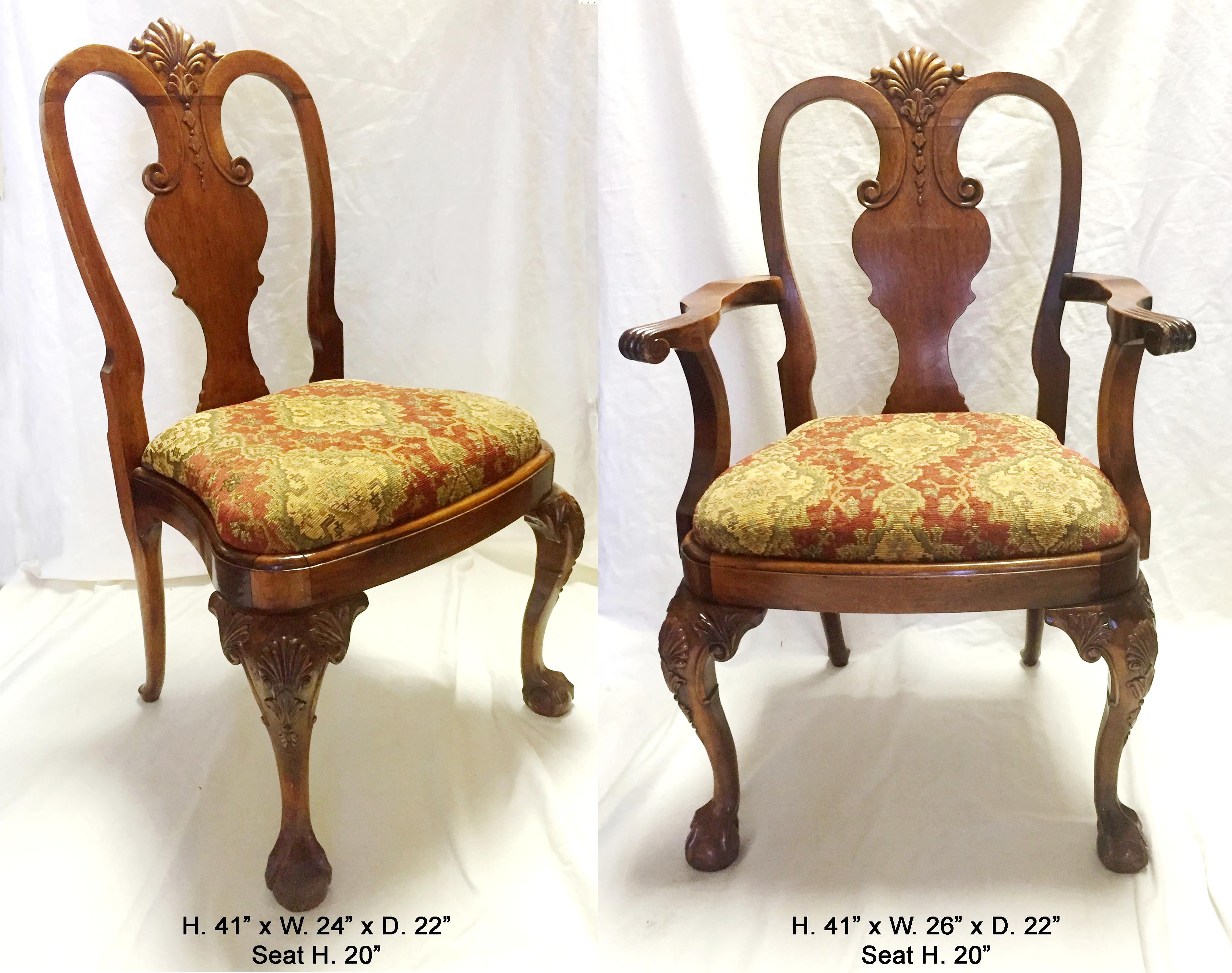 Desirable set of 8 English George II style walnut dining chairs, two arms and six sides.
All the toprails are beautifully carved walnut with shells as well as the legs, ending with claw and ball feet. 
First half of the 20th century
Measures: H