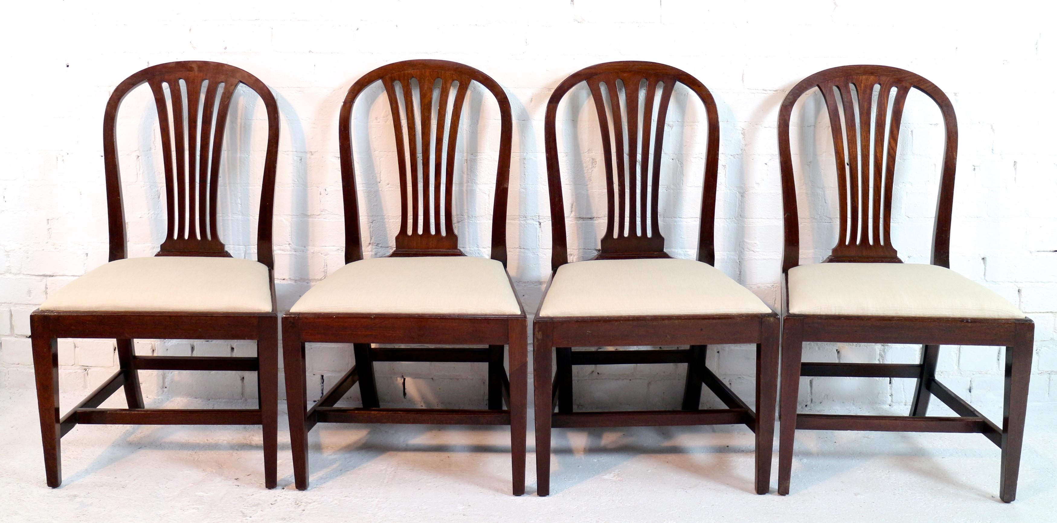 A set of eight George III mahogany fan back dining chairs attributed to Gillows of Lancaster. Comprising six single chairs and ladies and gentleman’s carver chairs this style of chair with an arched top rail and fan back was introduced by Gillows