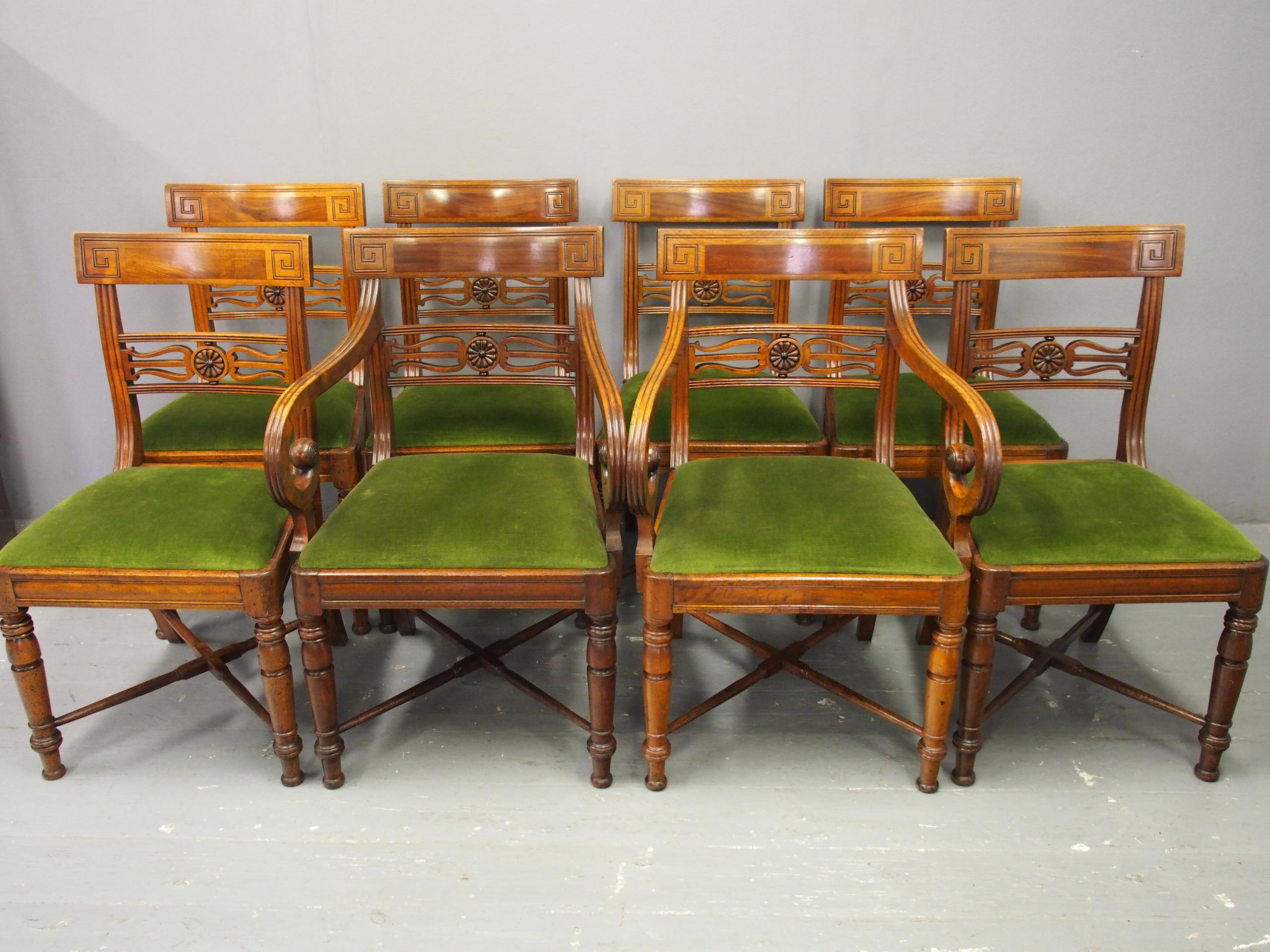 A good set of 8 mahogany George IV dining chairs, consisting of 6 side chairs and 2 armchairs, circa 1825. With Greek key pattern carving to the top rails, the central splat in a combination of reeding, carved flower heads and a lyre style pattern