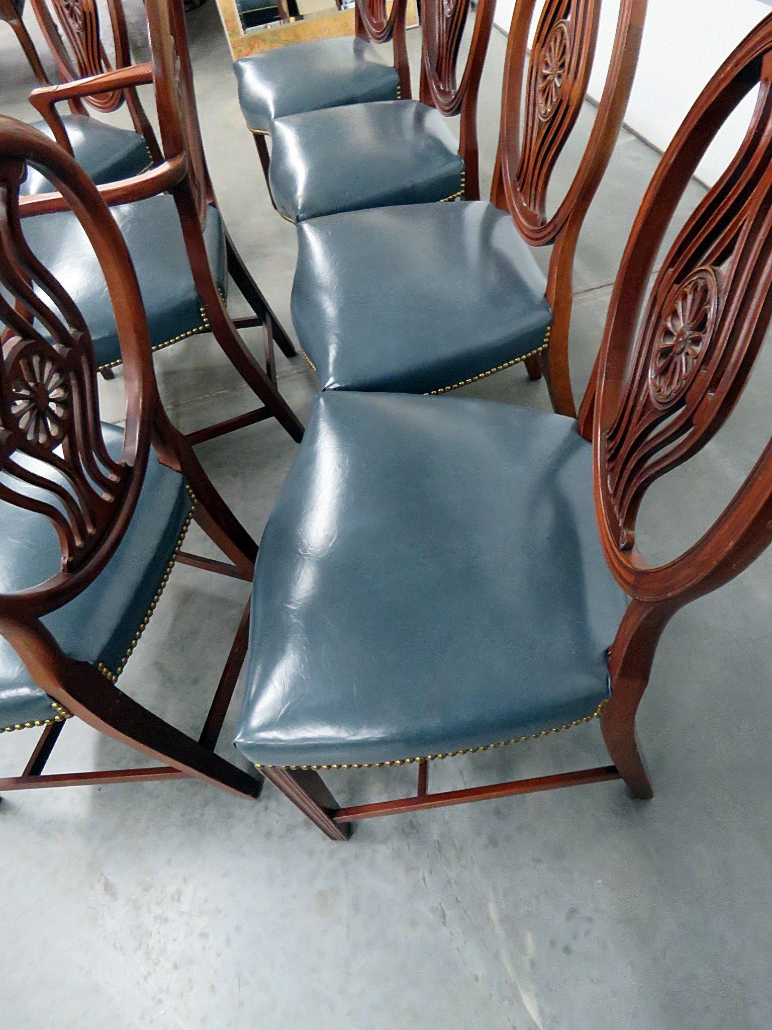 Set of 8 Georgian style dining room chairs with leather upholstery and nailhead trim. The 2 armchairs measure 28.5